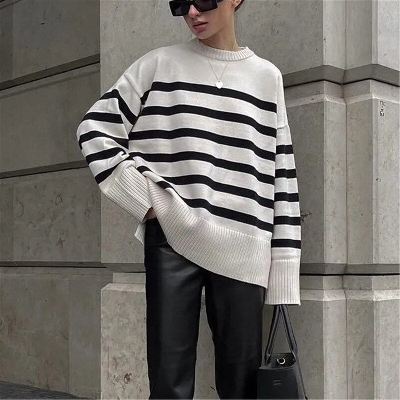 A stylish women's knit striped sweater featuring a turtleneck collar and full-length sleeves, perfect for autumn and winter wear.