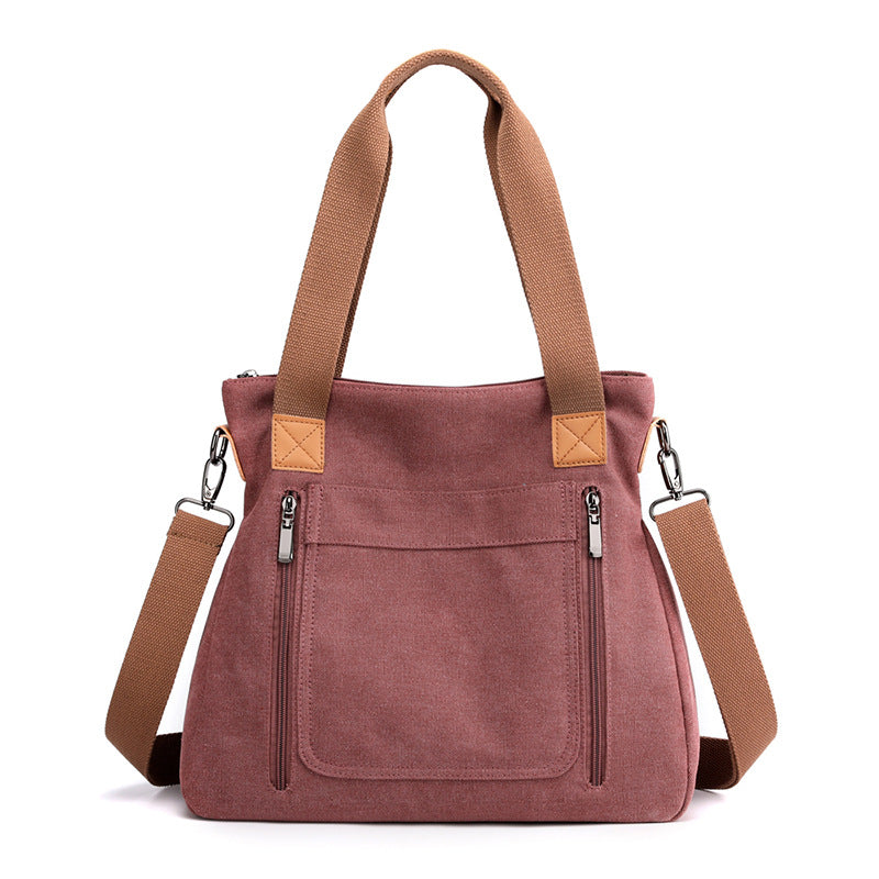 A stylish portable large-capacity female casual canvas shoulder bag in a horizontal square shape, featuring a zipper closure and soft handle.