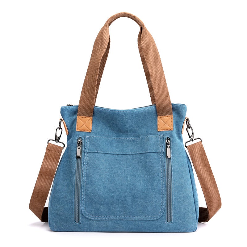 A stylish portable large-capacity female casual canvas shoulder bag in a horizontal square shape, featuring a zipper closure and soft handle.