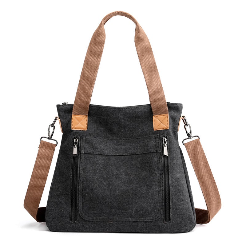 A stylish portable large-capacity female casual canvas shoulder bag in a horizontal square shape, featuring a zipper closure and soft handle.