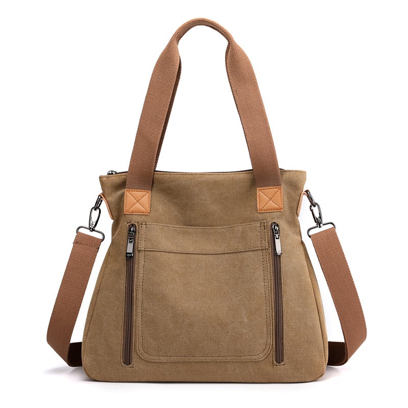 A stylish portable large-capacity female casual canvas shoulder bag in a horizontal square shape, featuring a zipper closure and soft handle.