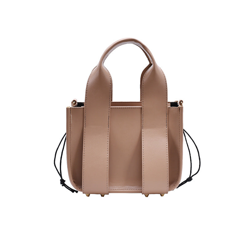 PU Fashion Urban Simplicity Bucket Handbag featuring rivet detailing, adjustable shoulder strap, and a soft surface finish.