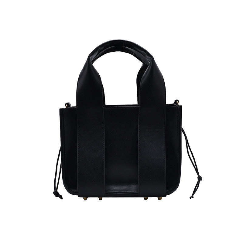 PU Fashion Urban Simplicity Bucket Handbag featuring rivet detailing, adjustable shoulder strap, and a soft surface finish.