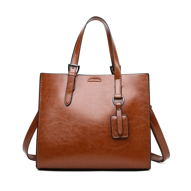 A stylish PU leather women's messenger bag in solid color, featuring a soft handle and zipper pocket.