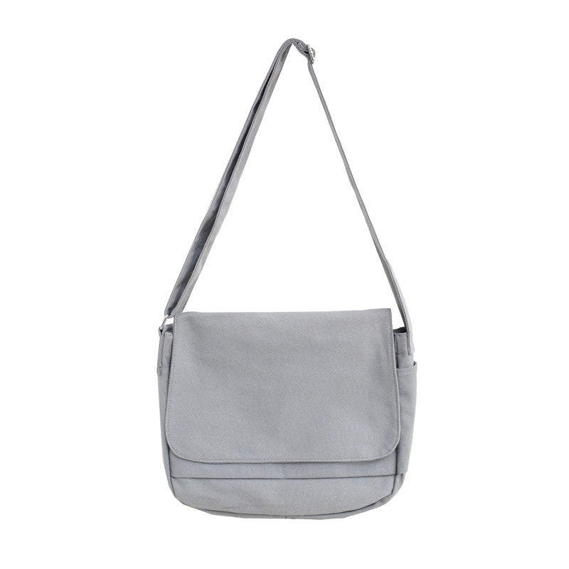 Pure Color Japanese Style Canvas Crossbody Bag in a horizontal square shape, featuring a soft handle and multiple internal pockets.