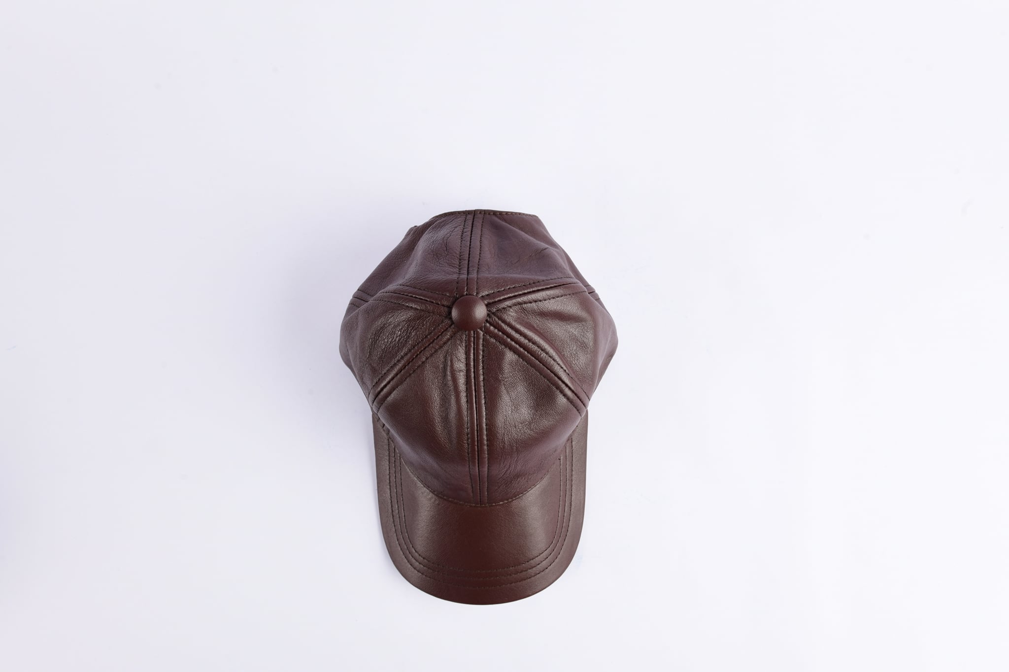 Brown pure leather cap with adjustable clip, showcasing its durable material and stylish design.