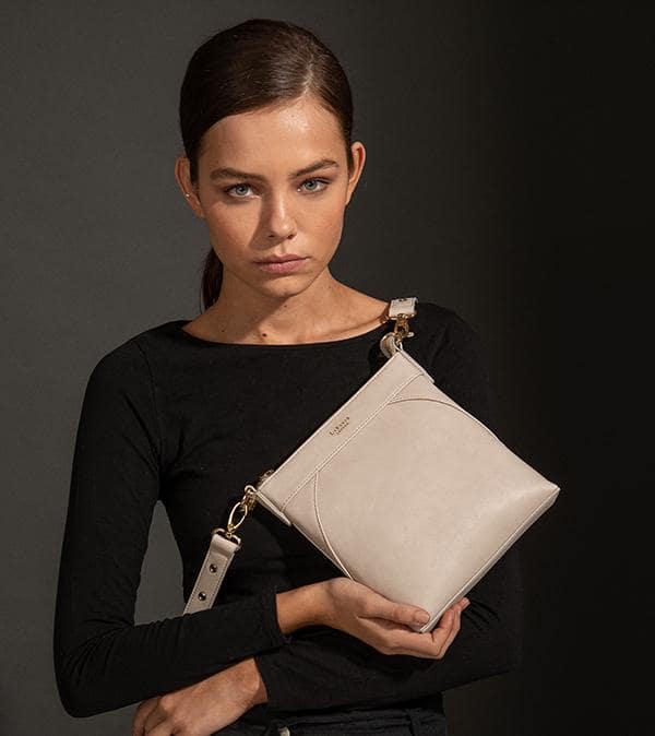 Raven Grey Vegan Crossbody Bag featuring gold hardware and adjustable strap, made from eco-friendly materials.