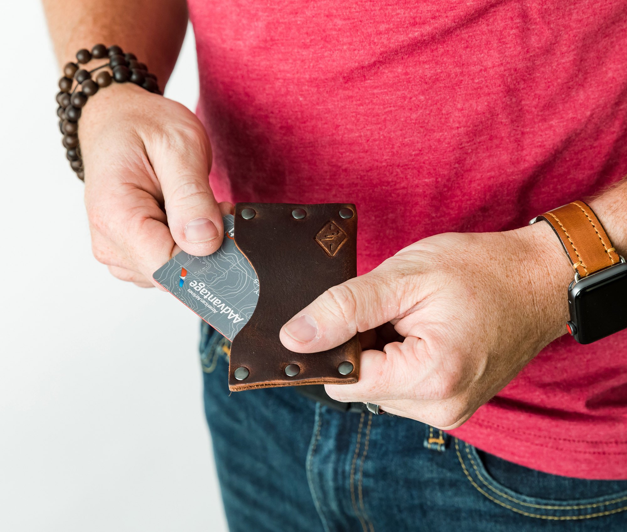 Rivet Wallet made of genuine full grain leather with stainless steel rivets, showcasing its minimalist design and personalization option.