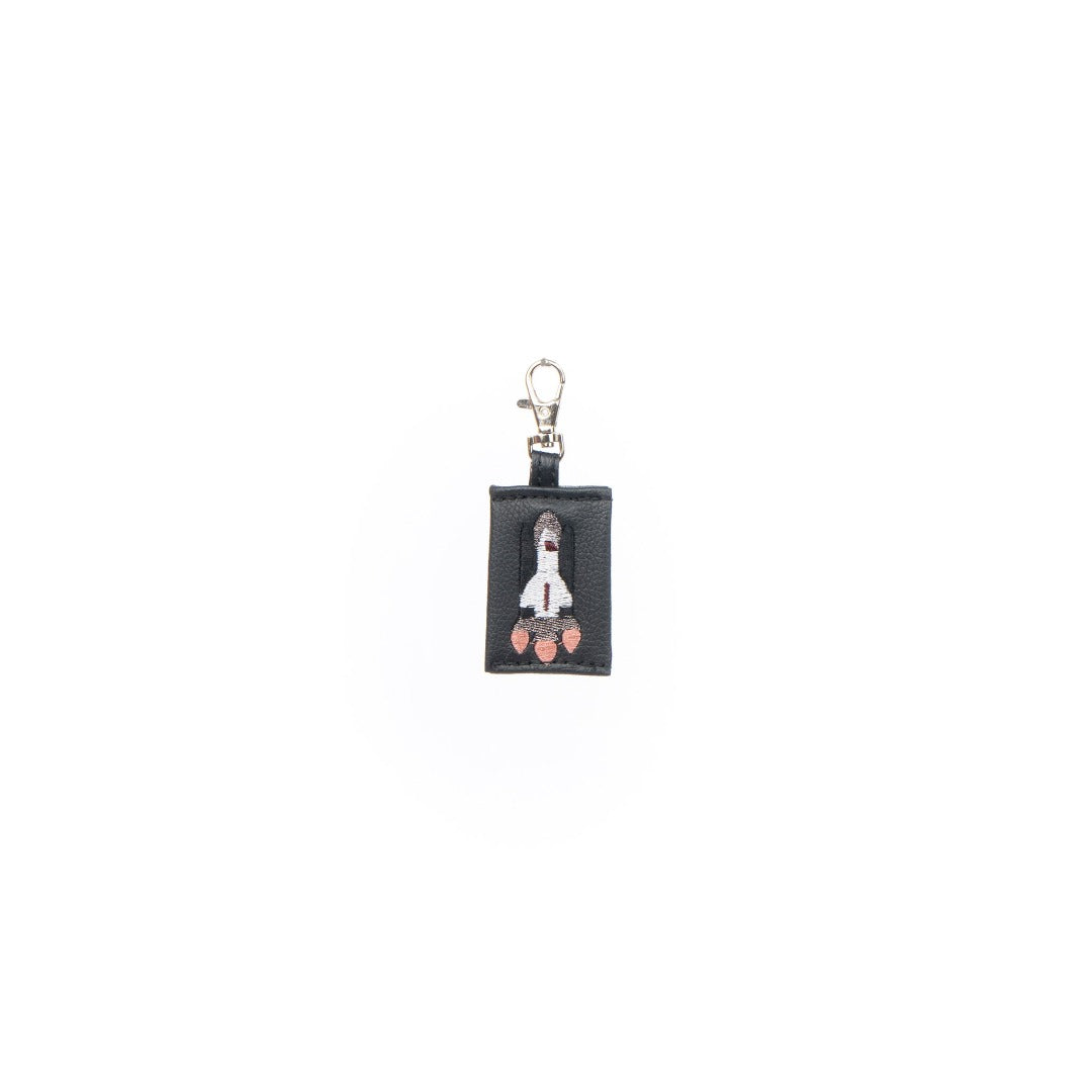 A colorful Rocket Charm made from vegan leather, designed as a keychain or bag decoration.