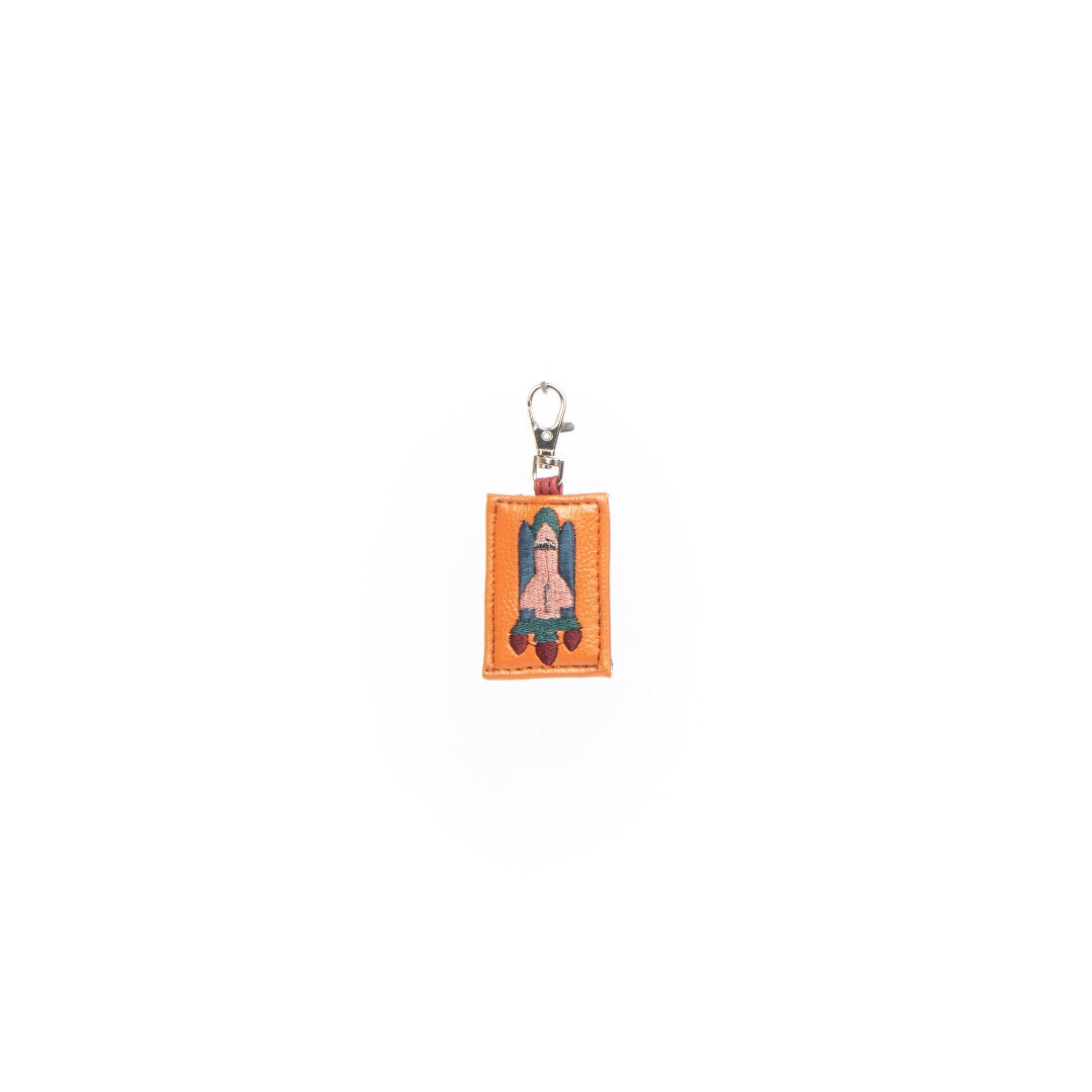 A colorful Rocket Charm made from vegan leather, designed as a keychain or bag decoration.