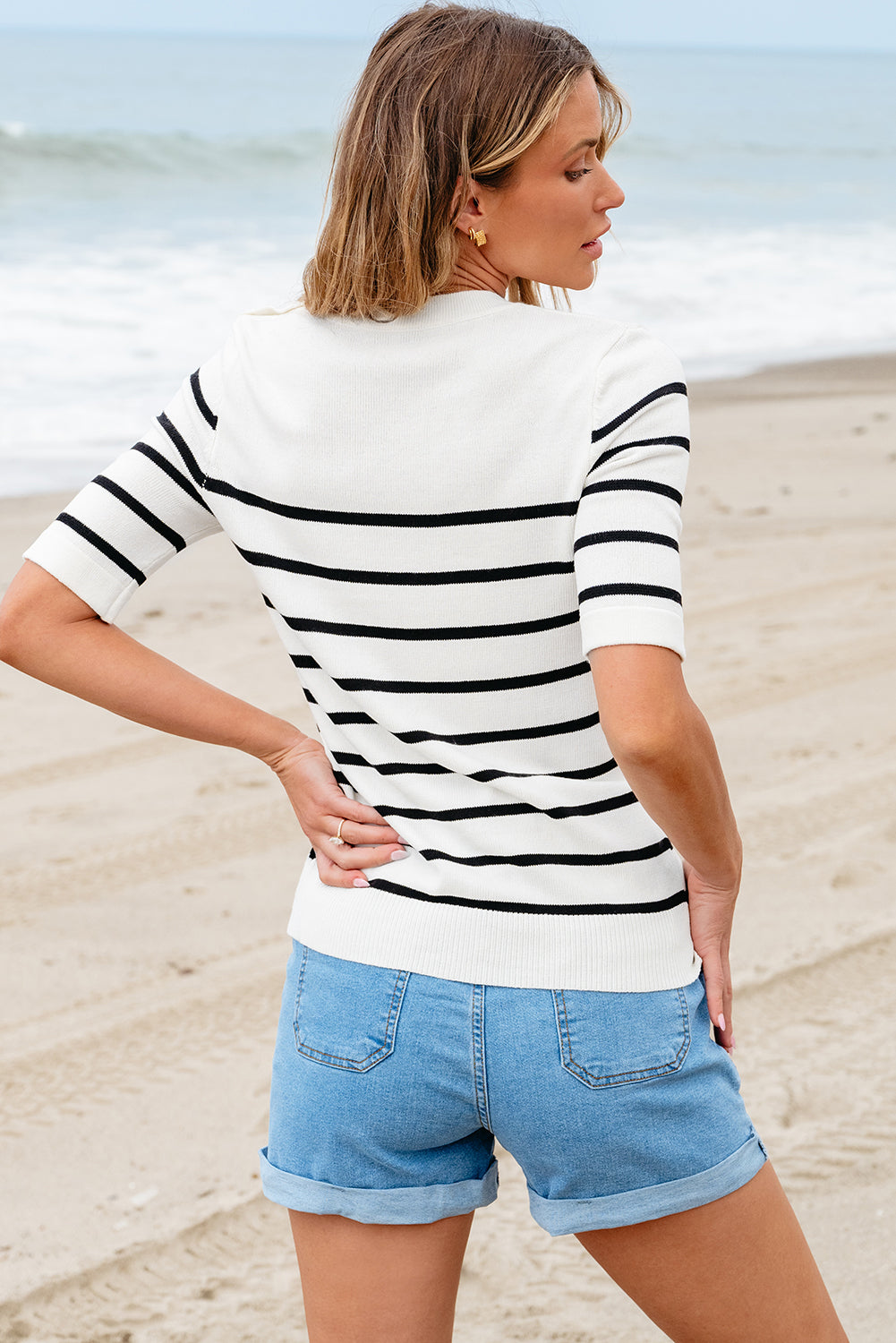 A stylish Round Neck Half Sleeve Knit Top featuring a decorative button, made from 100% viscose, displayed on a mannequin.