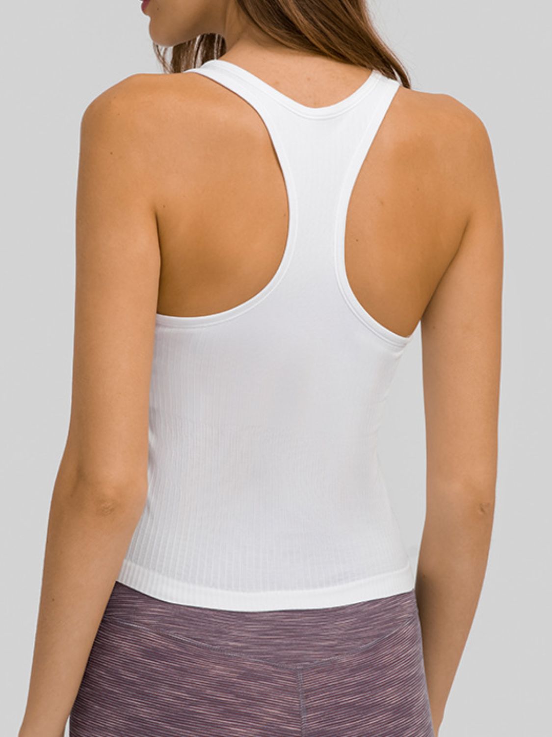 Round Neck Racerback Active Tank in various colors, showcasing removable padding and a comfortable fit.