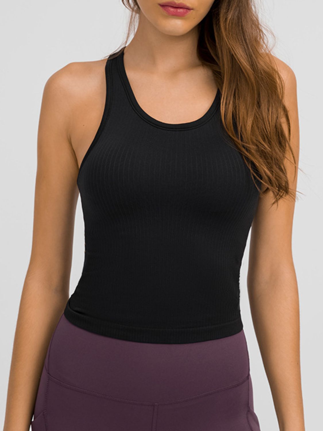 Round Neck Racerback Active Tank in various colors, showcasing removable padding and a comfortable fit.