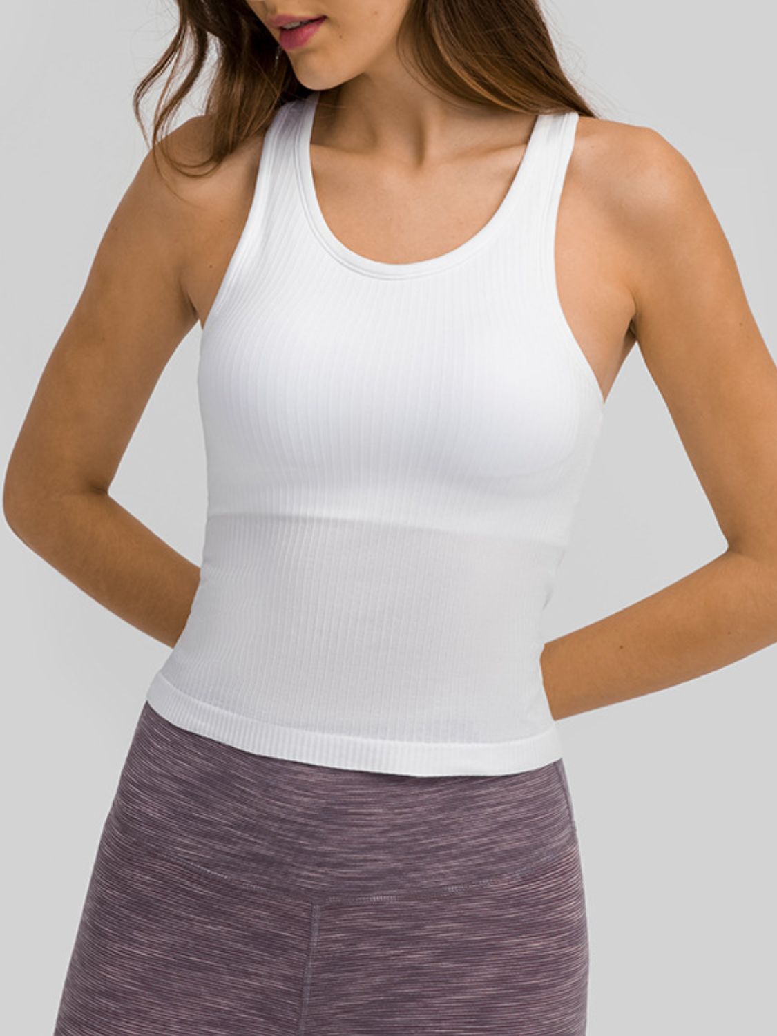 Round Neck Racerback Active Tank in various colors, showcasing removable padding and a comfortable fit.