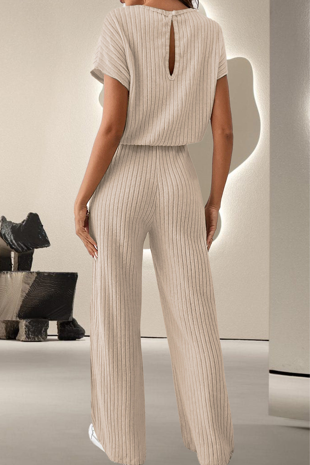 A stylish Round Neck Short Sleeve Jumpsuit displayed on a mannequin, showcasing its chic design and comfortable fit.