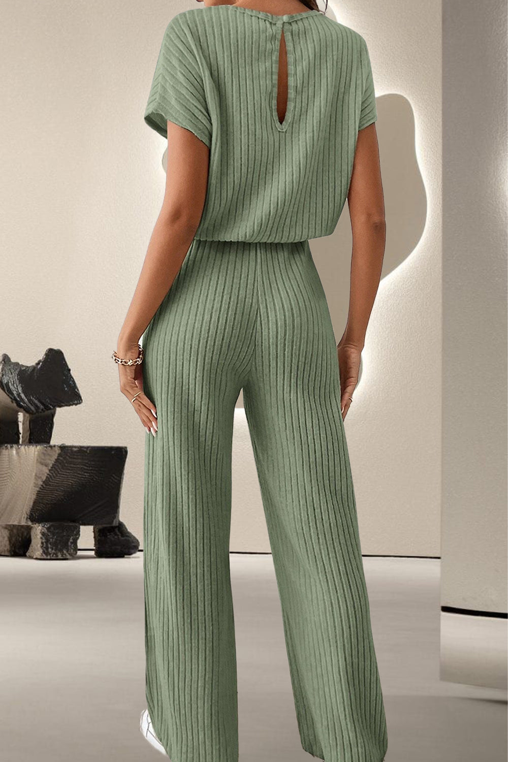 A stylish Round Neck Short Sleeve Jumpsuit displayed on a mannequin, showcasing its chic design and comfortable fit.