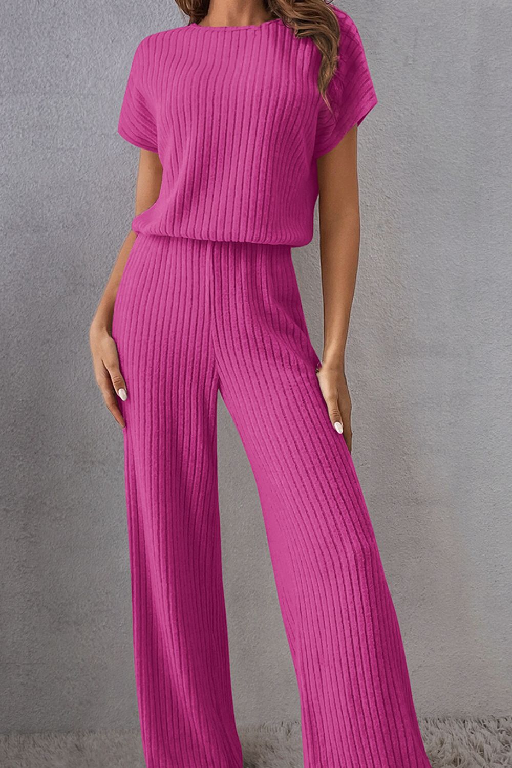 A stylish Round Neck Short Sleeve Jumpsuit displayed on a mannequin, showcasing its chic design and comfortable fit.