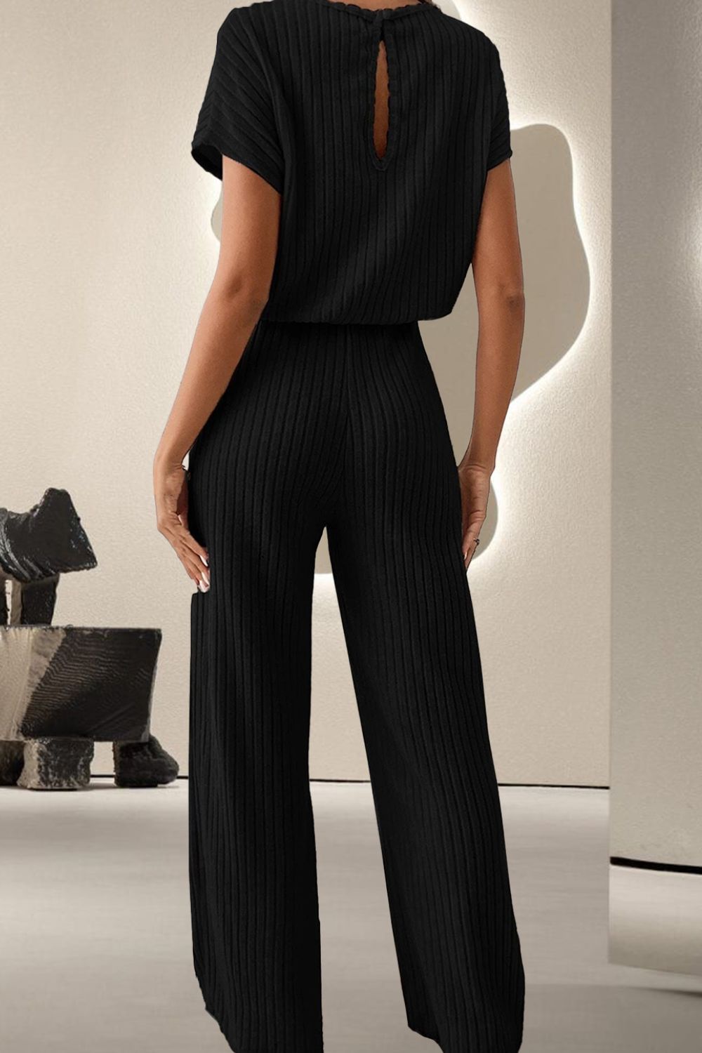 A stylish Round Neck Short Sleeve Jumpsuit displayed on a mannequin, showcasing its chic design and comfortable fit.