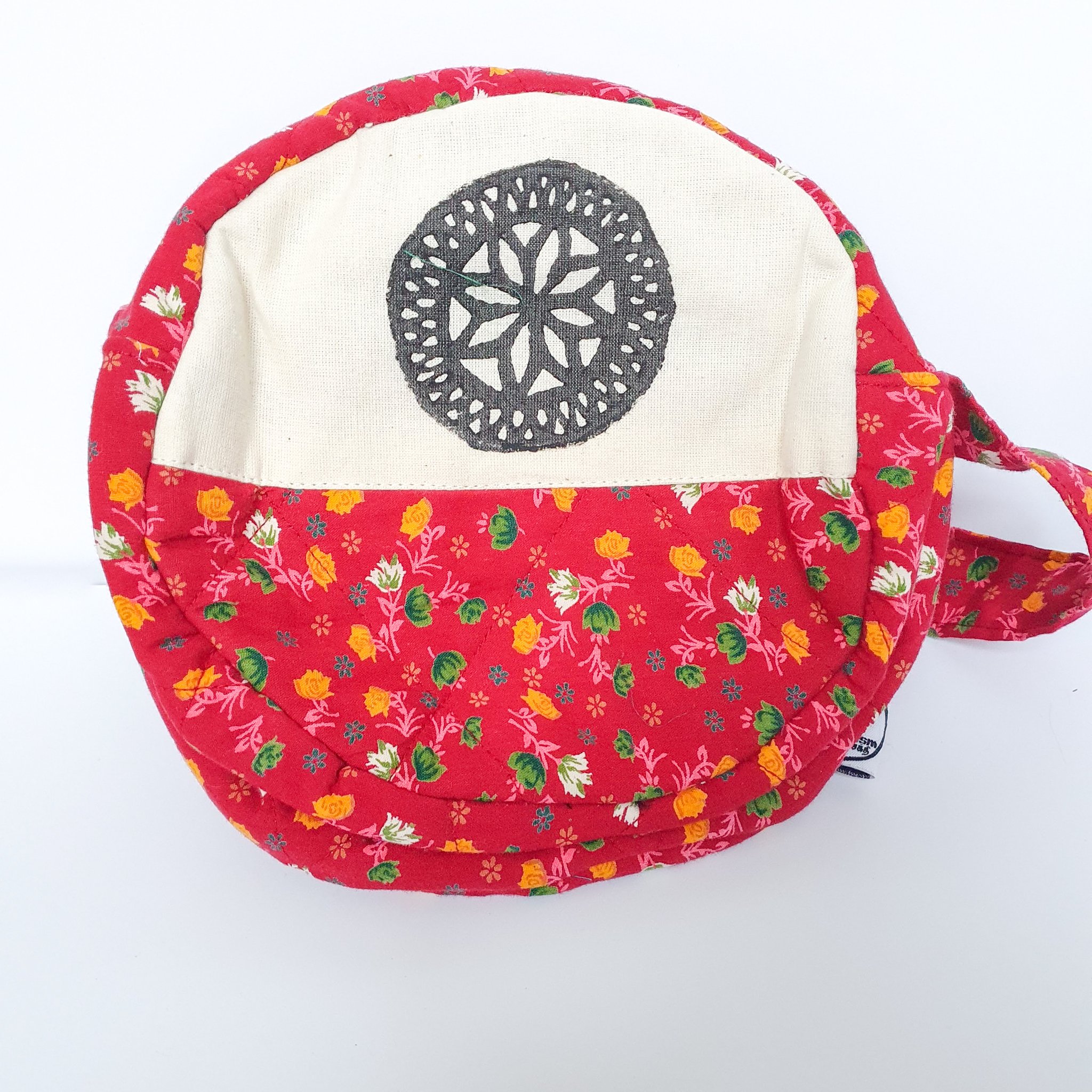 A vibrant round shoulder bag made from repurposed saris, showcasing unique patterns and colors, handcrafted by artisans in India.