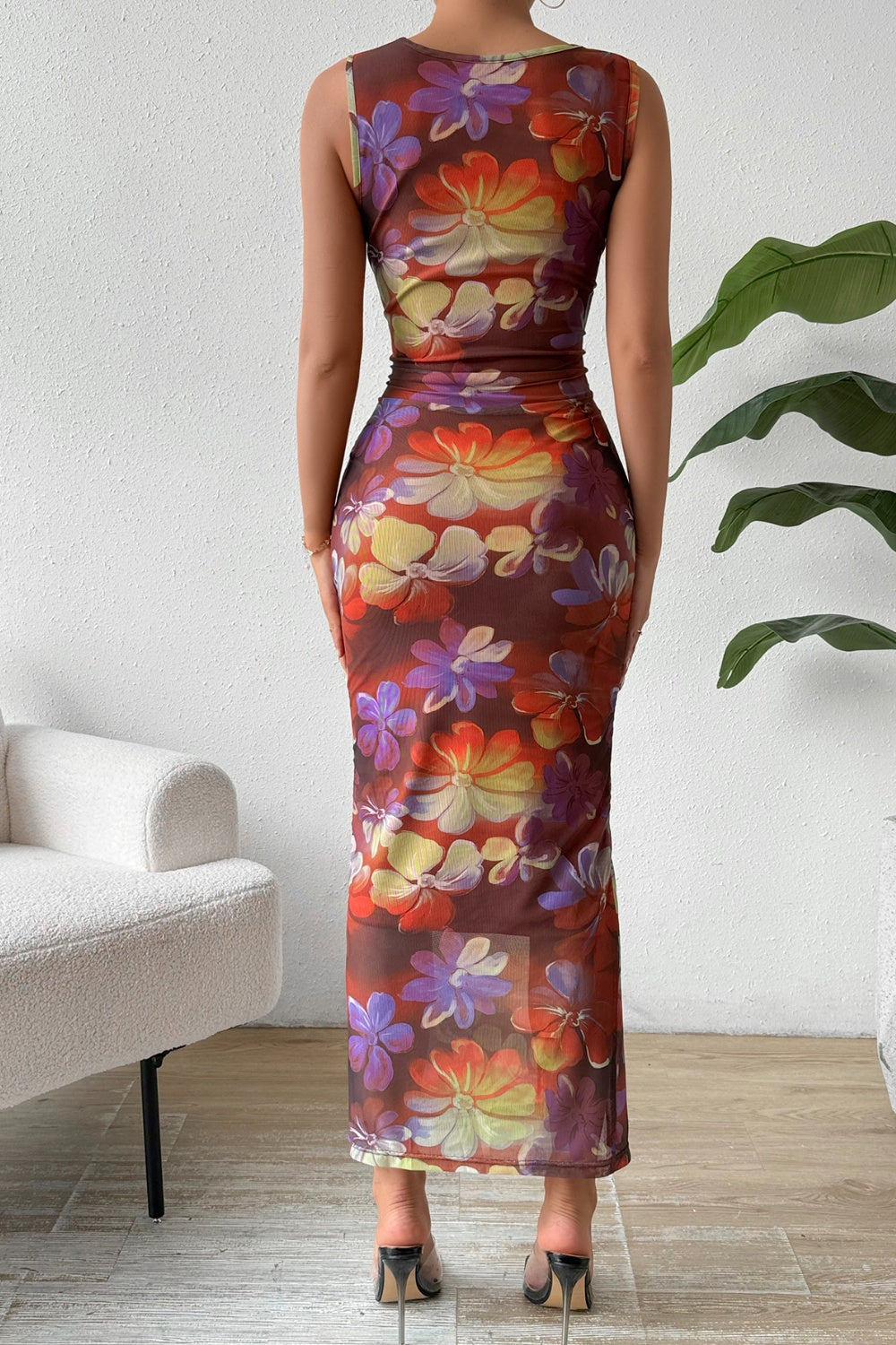 A stylish ruched slit printed round neck sleeveless dress in a vibrant pattern, showcasing its elegant design and comfortable fit.