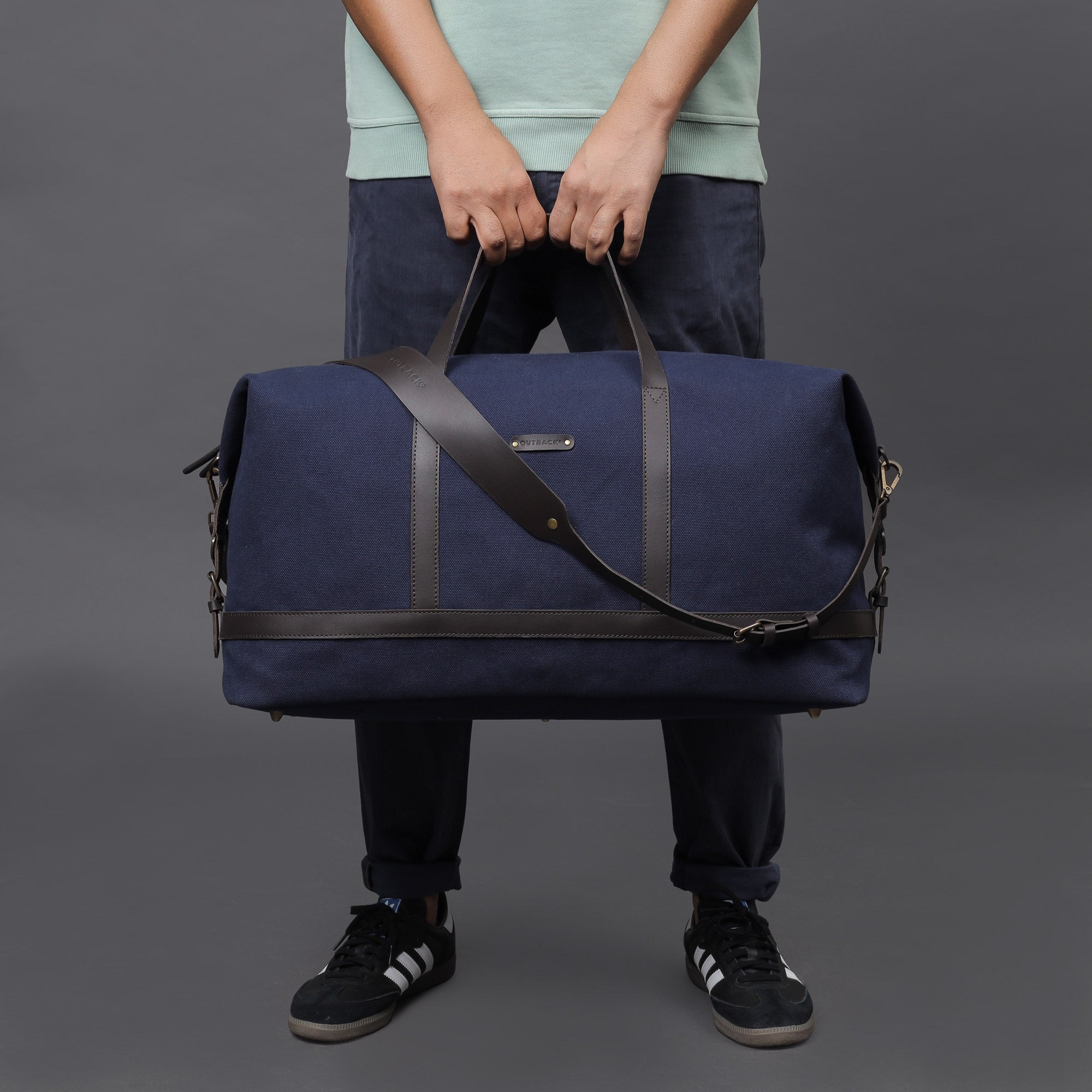 Runway Canvas Travel Bag showcasing its vintage design, adjustable strap, and durable materials, perfect for stylish travel.