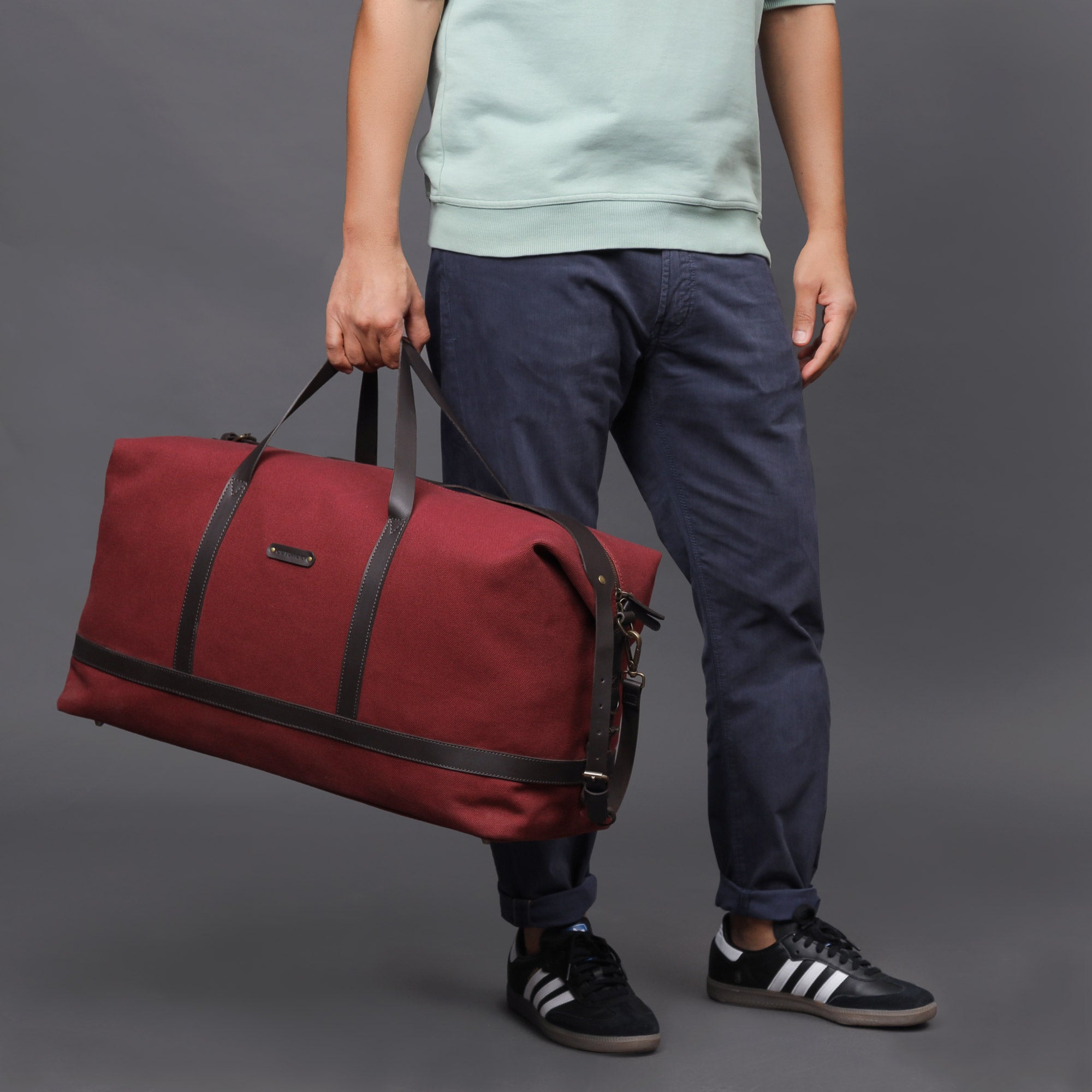 Runway Canvas Travel Bag showcasing its vintage design, adjustable shoulder strap, and durable materials.