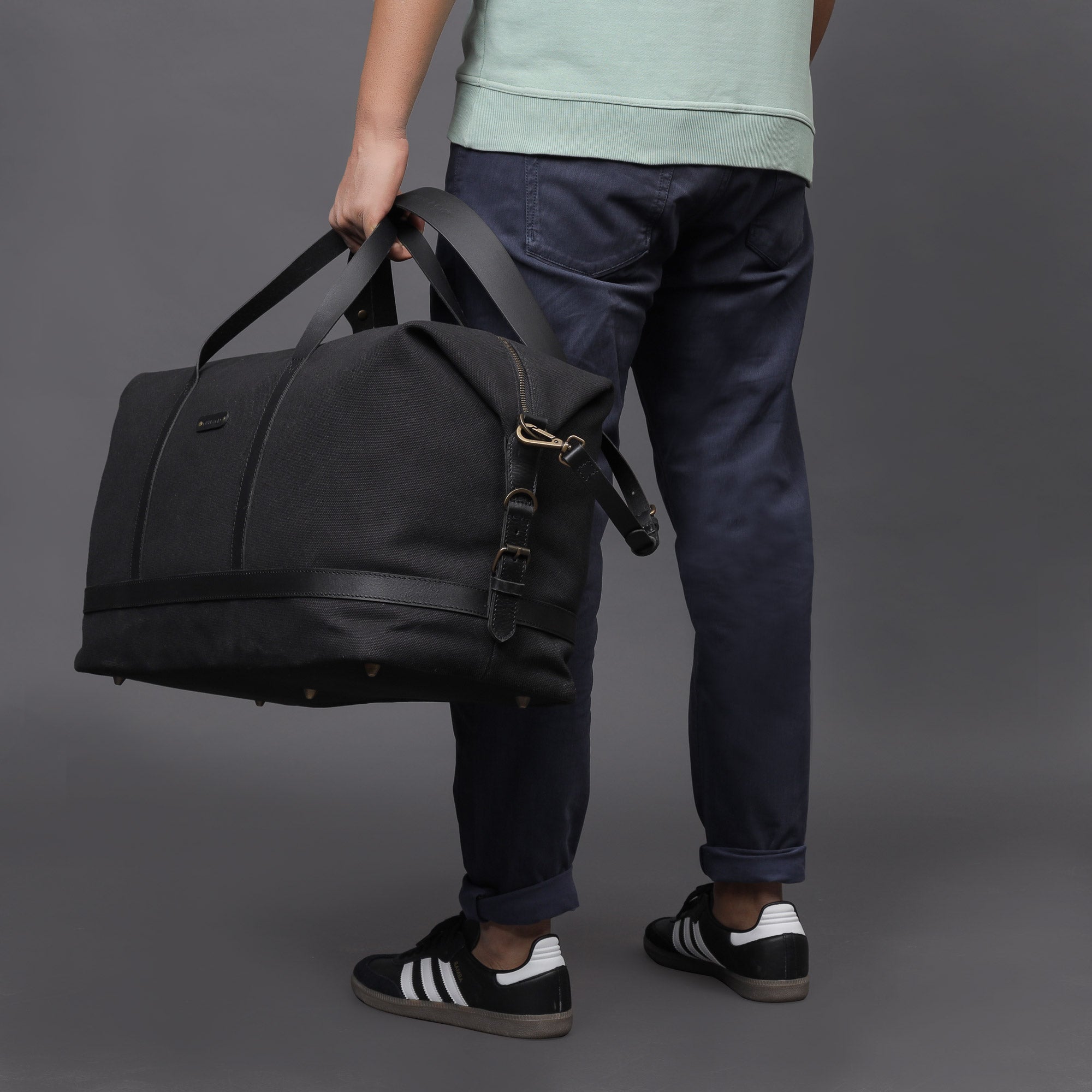 Runway Canvas Travel Bag featuring durable cotton canvas, adjustable leather strap, and vintage buckles.