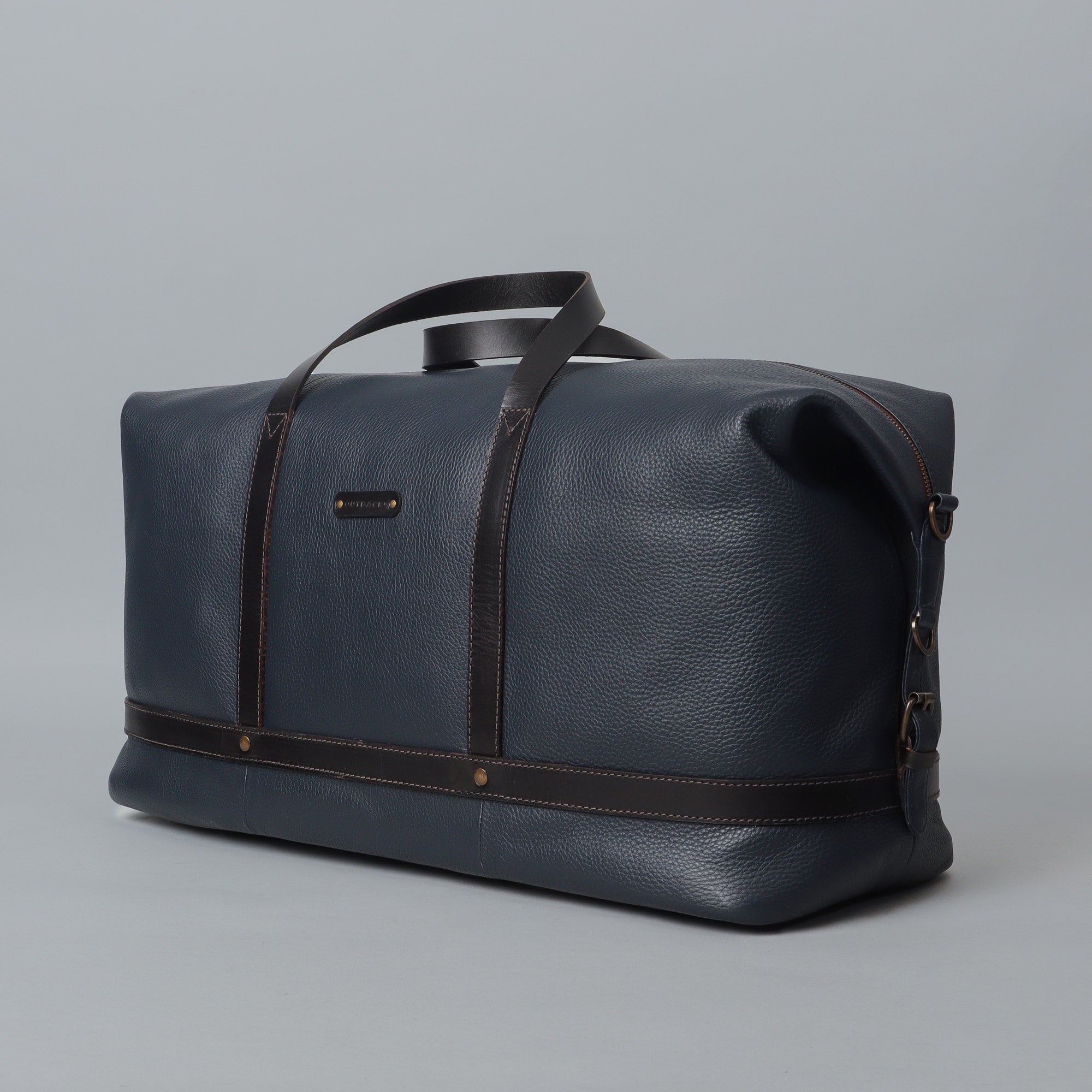 Runway Leather Travel Bag made from premium full grain leather, featuring vintage buckles and an adjustable shoulder strap.