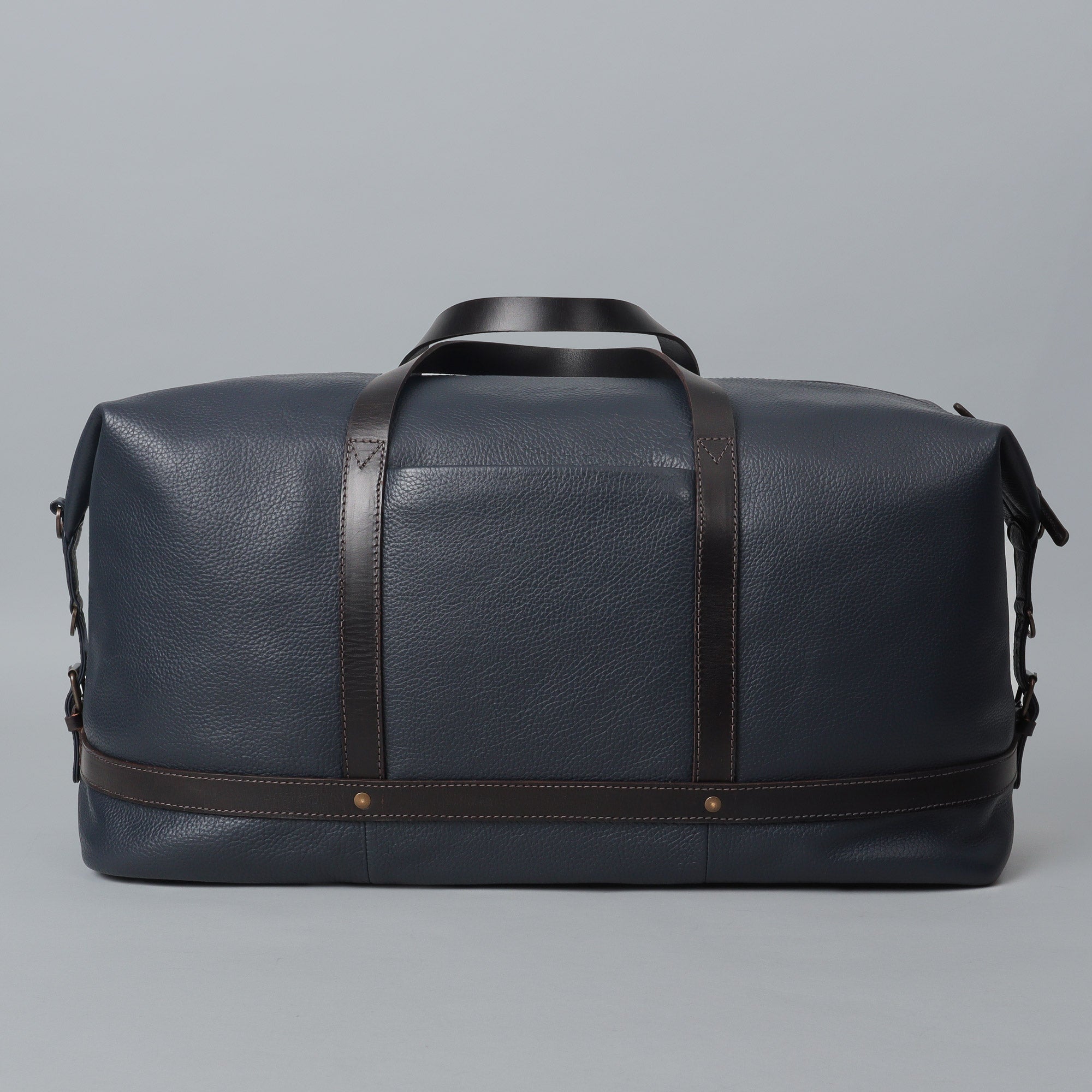 Runway Leather Travel Bag made from premium full grain leather, featuring vintage buckles and an adjustable shoulder strap.