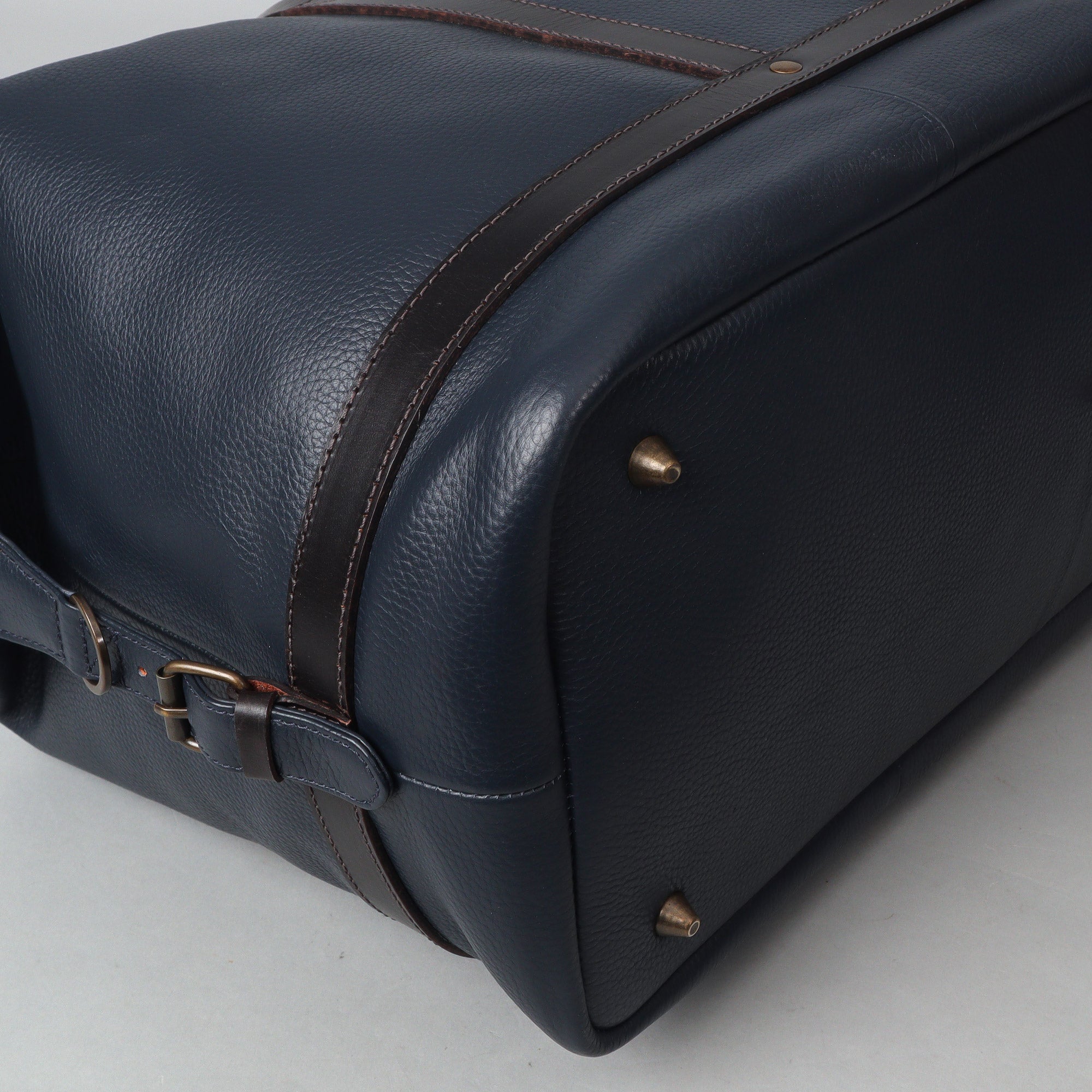 Runway Leather Travel Bag made from premium full grain leather, featuring vintage buckles and an adjustable shoulder strap.