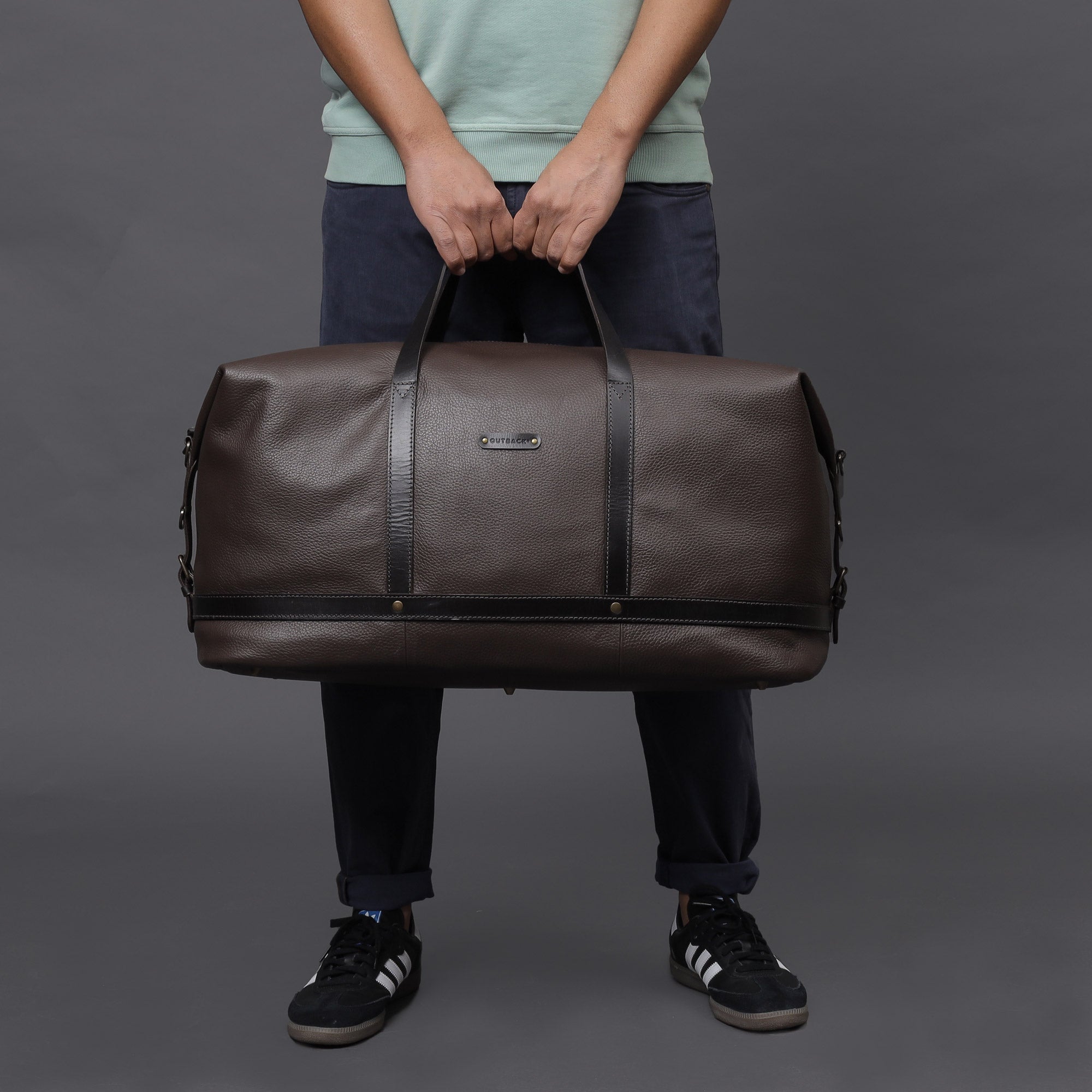 Runway Leather Travel Bag made from premium full grain leather, featuring adjustable shoulder strap, vintage buckles, and durable interior.