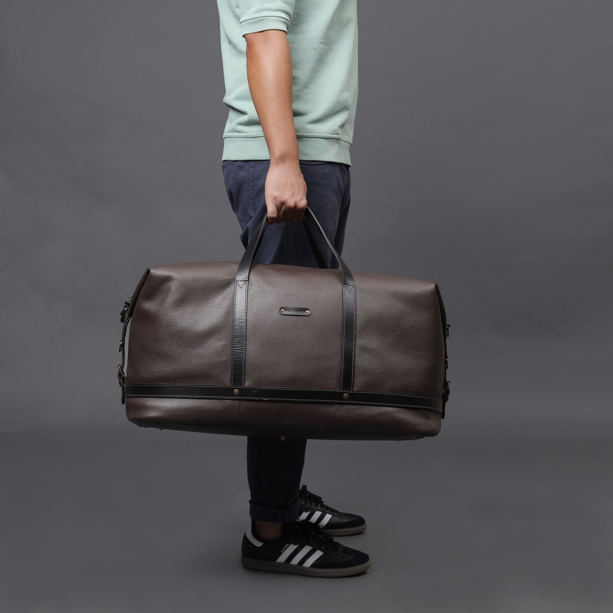 Runway Leather Travel Bag made from premium full grain leather, featuring adjustable shoulder strap, vintage buckles, and durable interior.