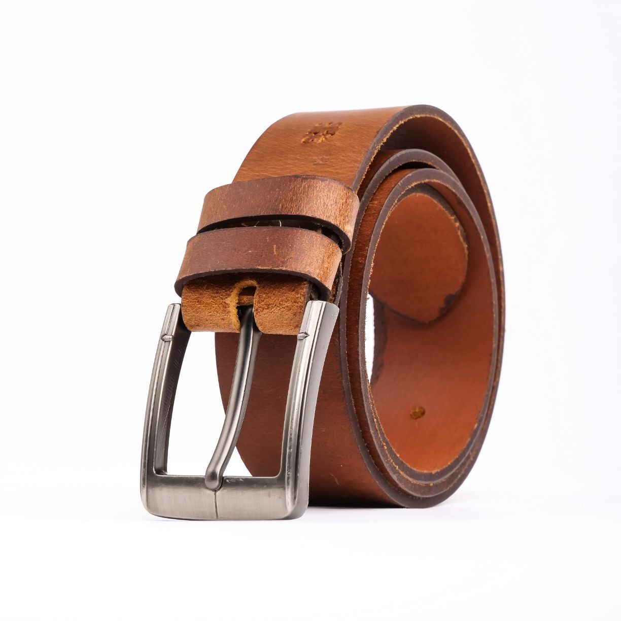 A rustic leather belt with double thread stitching and a single pin buckle, showcasing its quality and style.