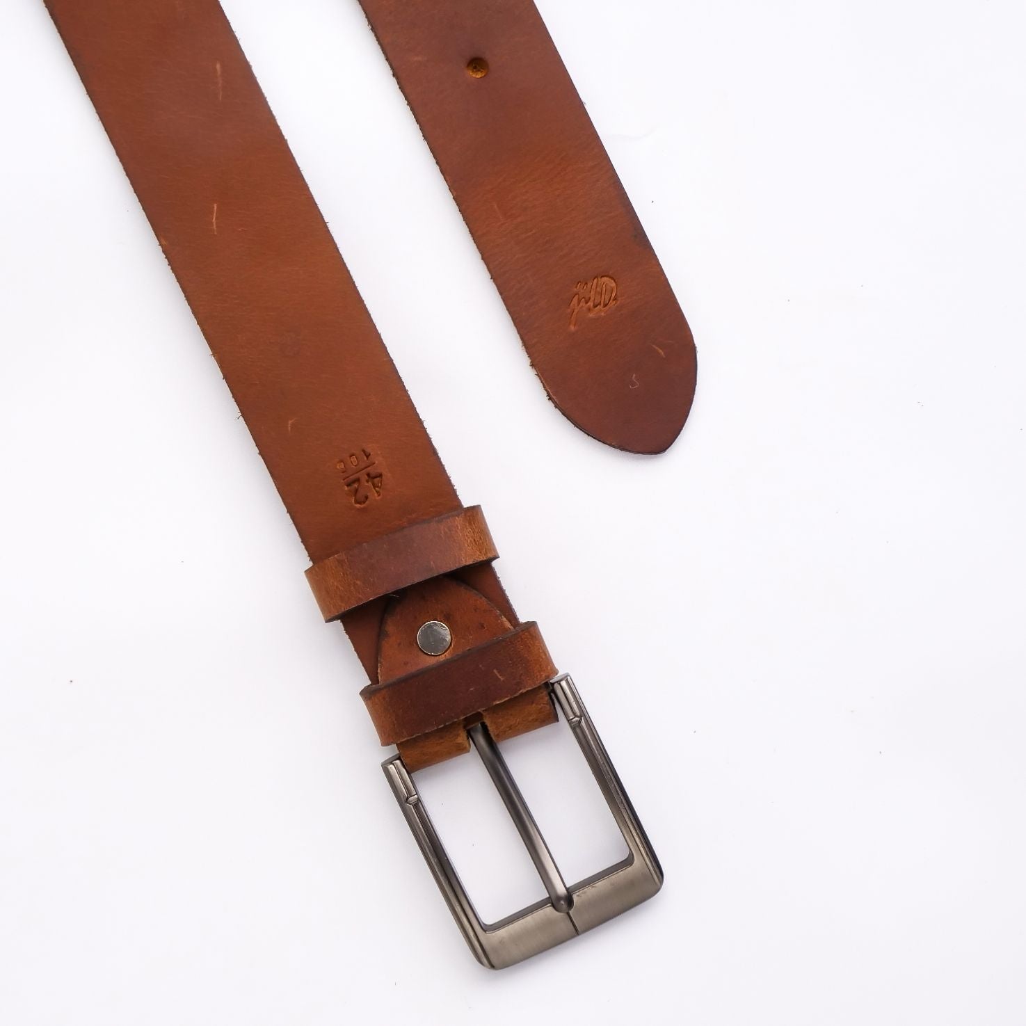 A rustic leather belt with double thread stitching and a single pin buckle, showcasing its quality and style.