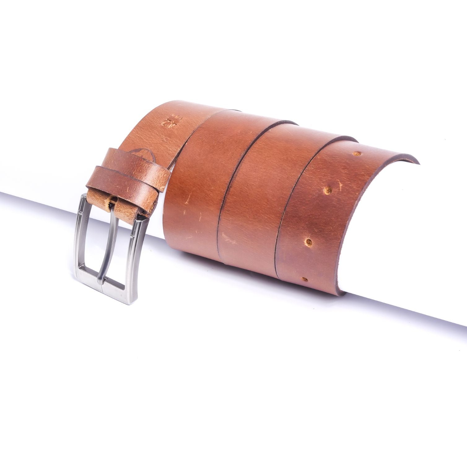 A rustic leather belt with double thread stitching and a single pin buckle, showcasing its quality and style.