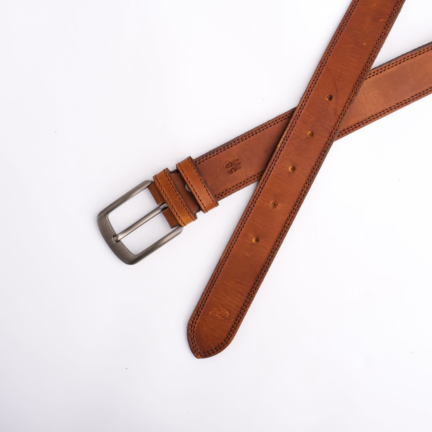 A rustic leather belt with double thread stitching and a single pin buckle, showcasing its quality and style.