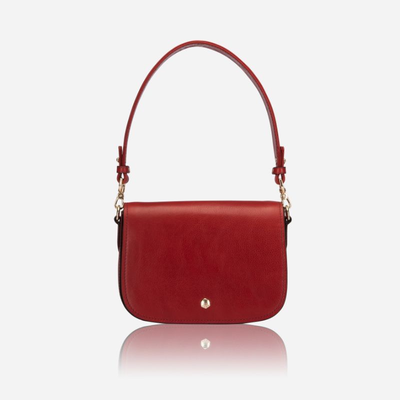 A vibrant red saddle bag featuring RFID protection, showcasing its stylish design and compact size.