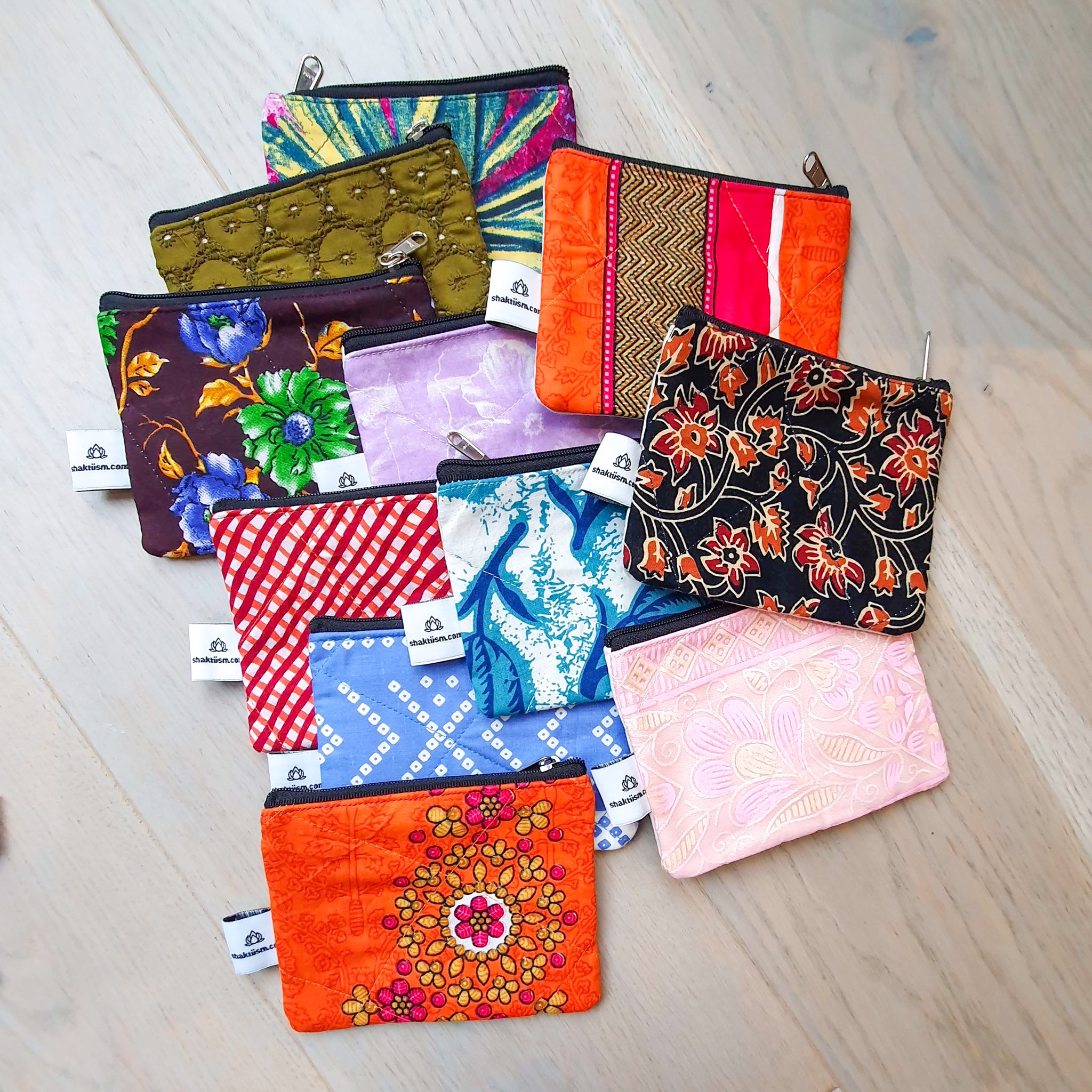 Colorful Sari coin purses made from reclaimed fabric, showcasing unique patterns and designs, ethically handmade by artisans in India.