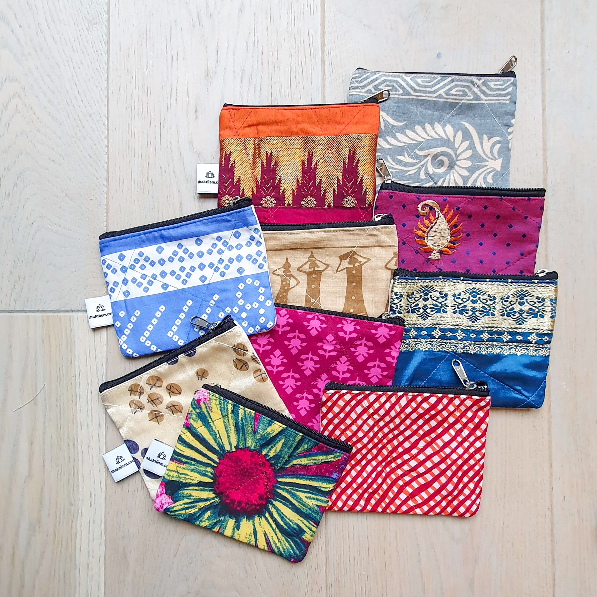 Colorful Sari coin purses made from reclaimed fabric, showcasing unique patterns and designs, ethically handmade by artisans in India.