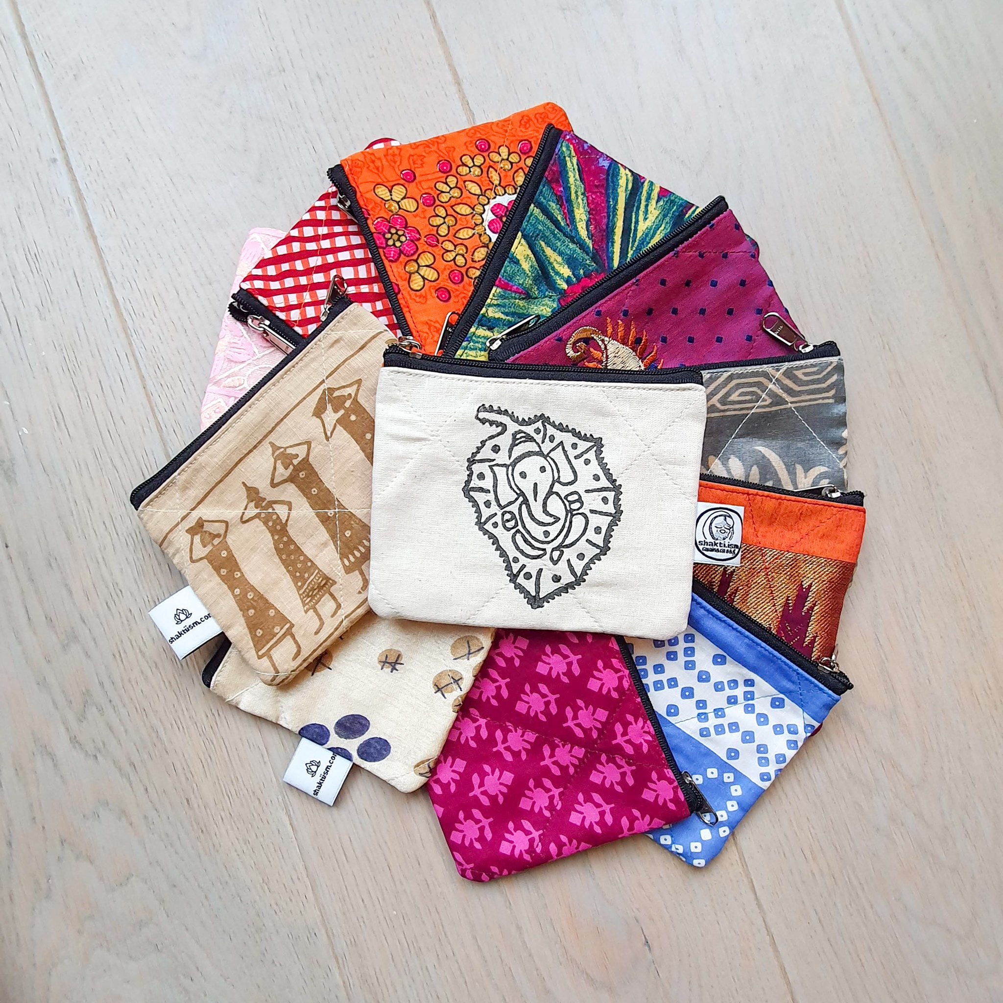 Colorful Sari coin purses made from reclaimed fabric, showcasing unique patterns and designs, ethically handmade by artisans in India.