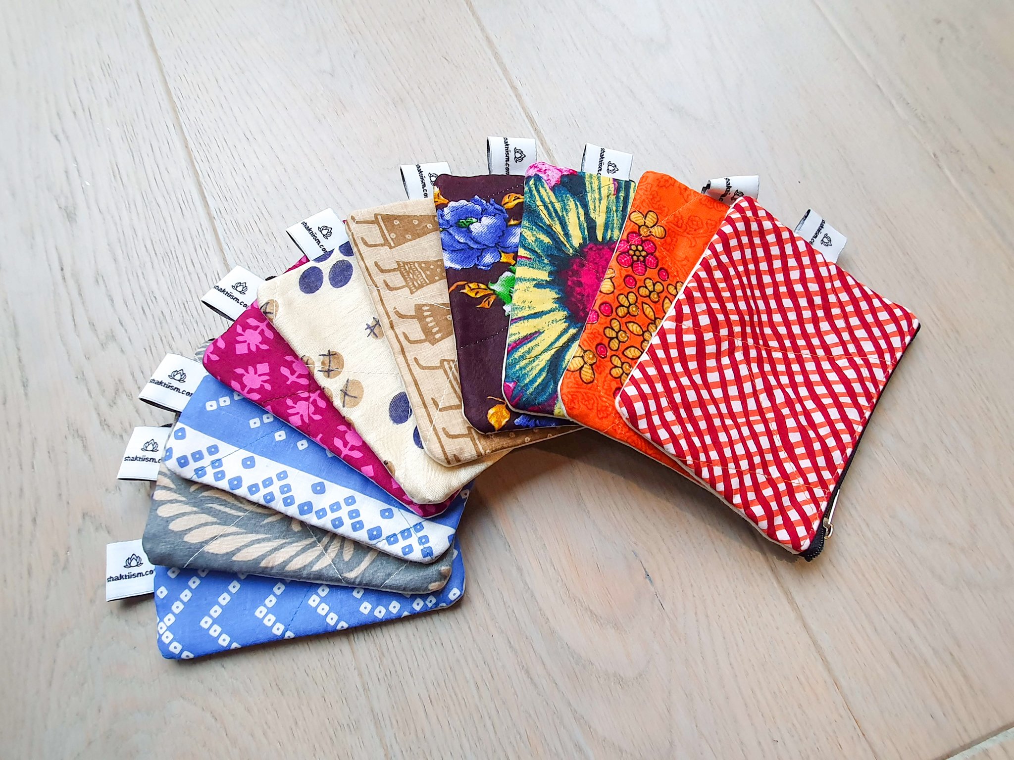 Colorful Sari coin purses made from reclaimed fabric, showcasing unique patterns and designs, ethically handmade by artisans in India.