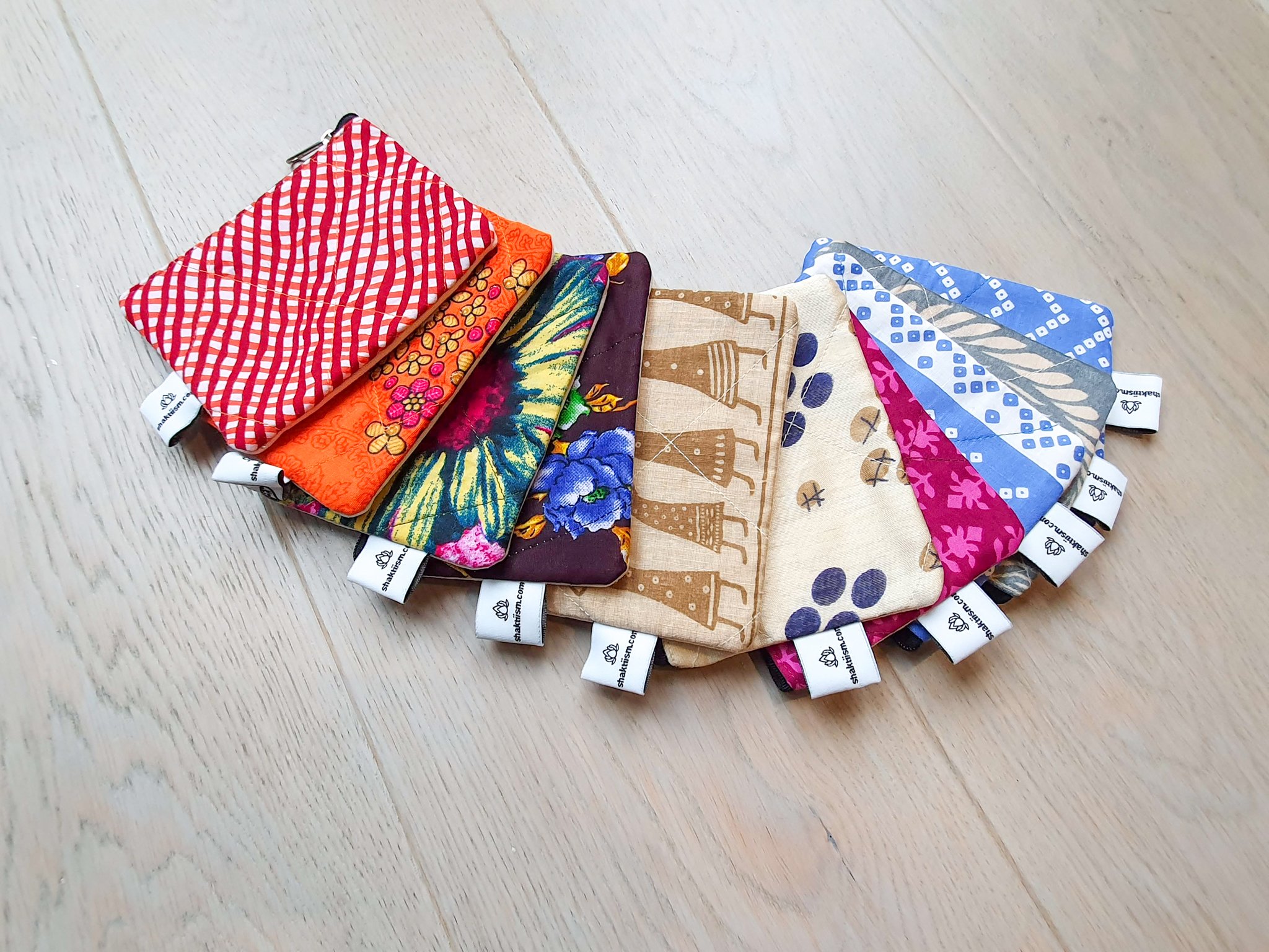 Colorful Sari coin purses made from reclaimed fabric, showcasing unique patterns and designs, ethically handmade by artisans in India.