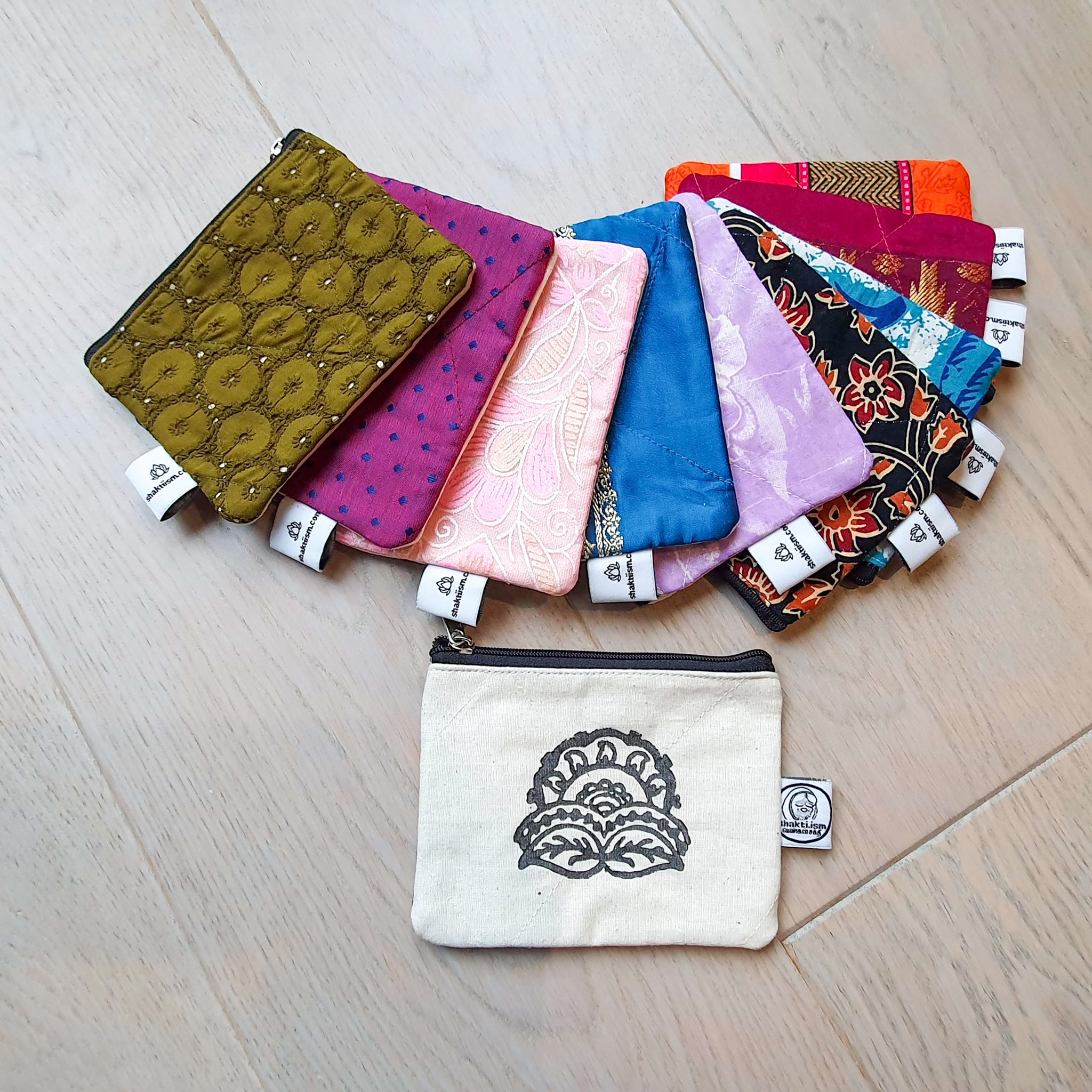 Colorful Sari coin purses made from reclaimed fabric, showcasing unique patterns and designs, ethically handmade by artisans in India.