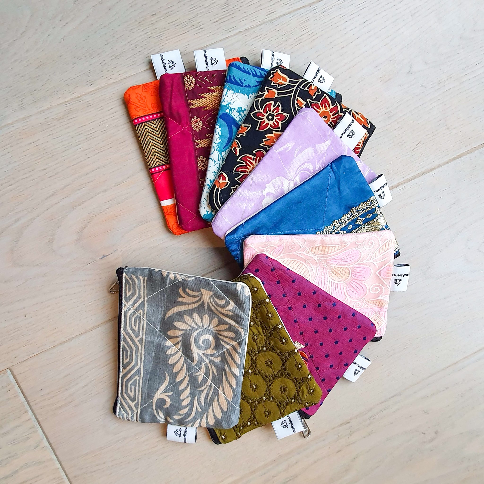 Colorful Sari coin purses made from reclaimed fabric, showcasing unique patterns and designs, ethically handmade by artisans in India.