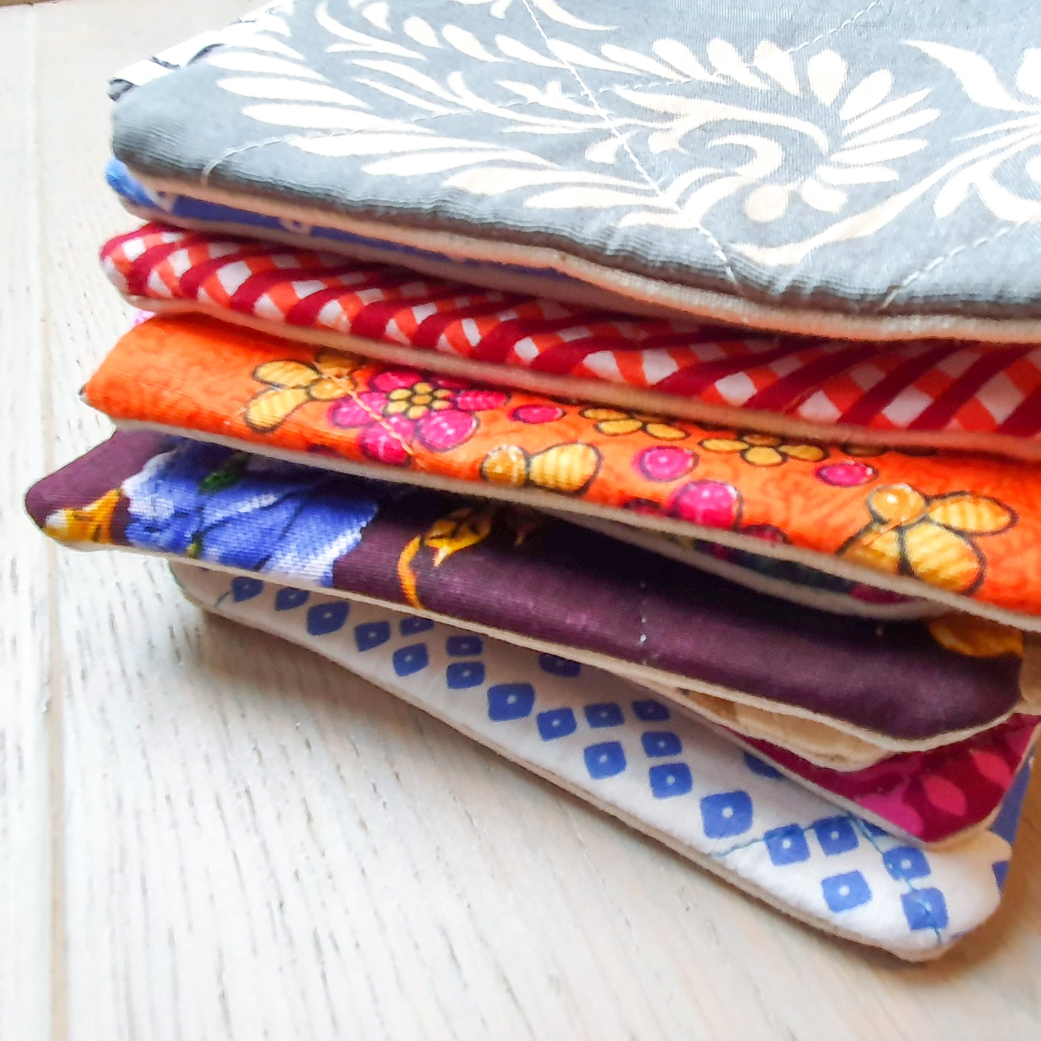 Colorful Sari coin purses made from reclaimed fabric, showcasing unique patterns and designs, ethically handmade by artisans in India.