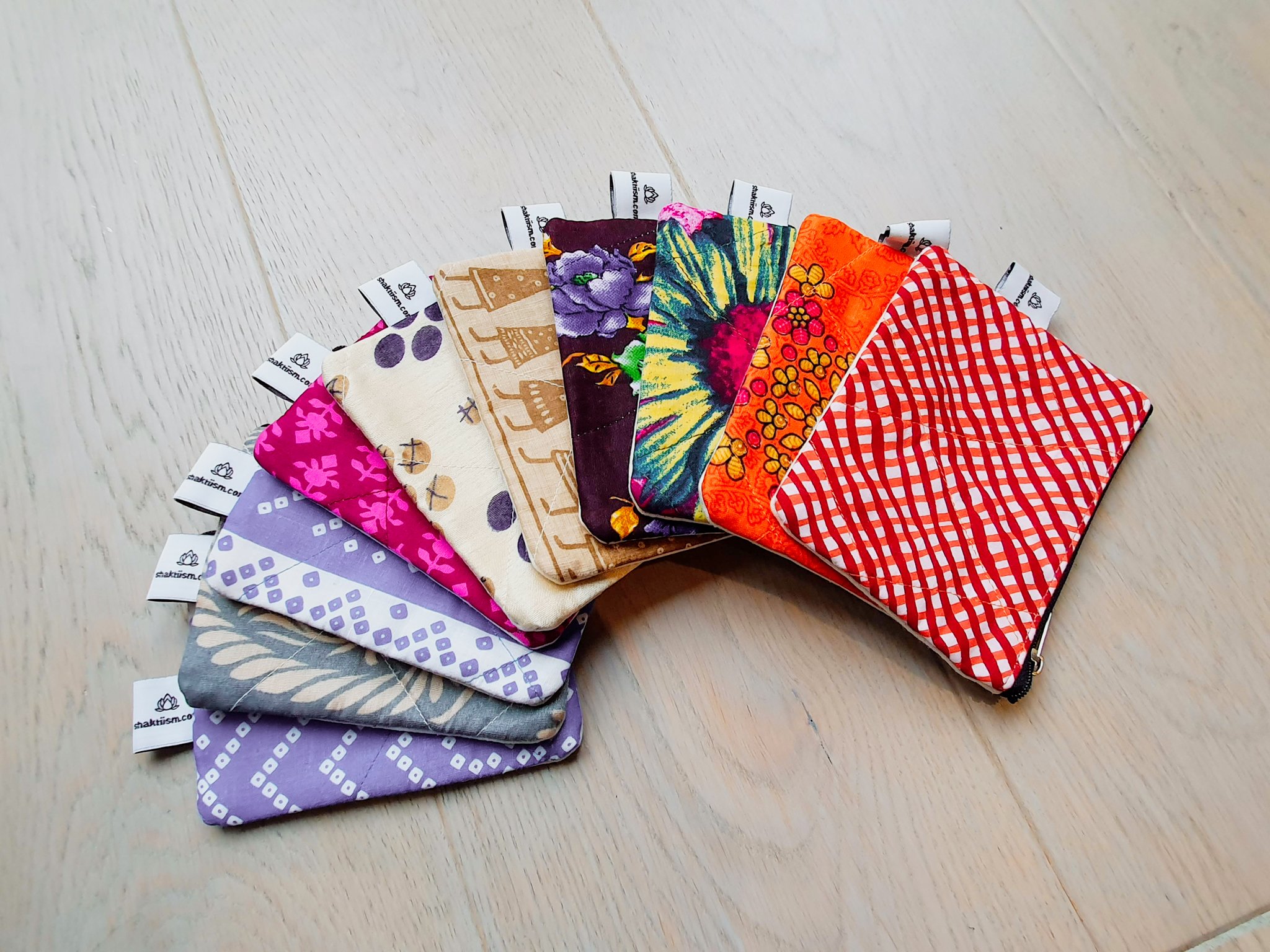 Colorful Sari coin purses made from reclaimed fabric, showcasing unique patterns and designs, ethically handmade by artisans in India.