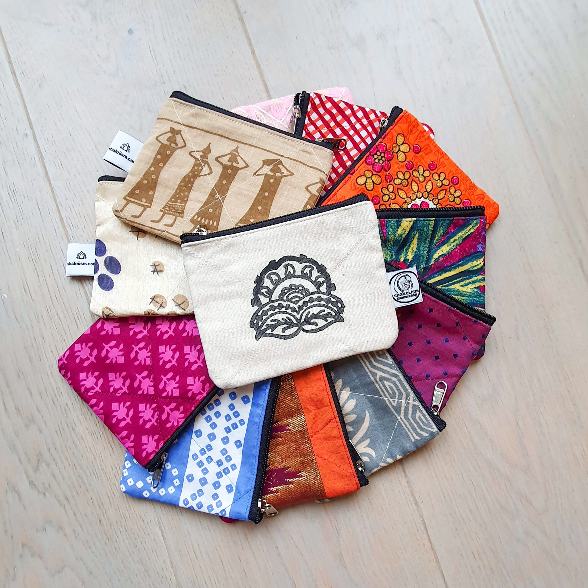 Colorful Sari coin purses made from reclaimed fabric, showcasing unique patterns and designs, ethically handmade by artisans in India.