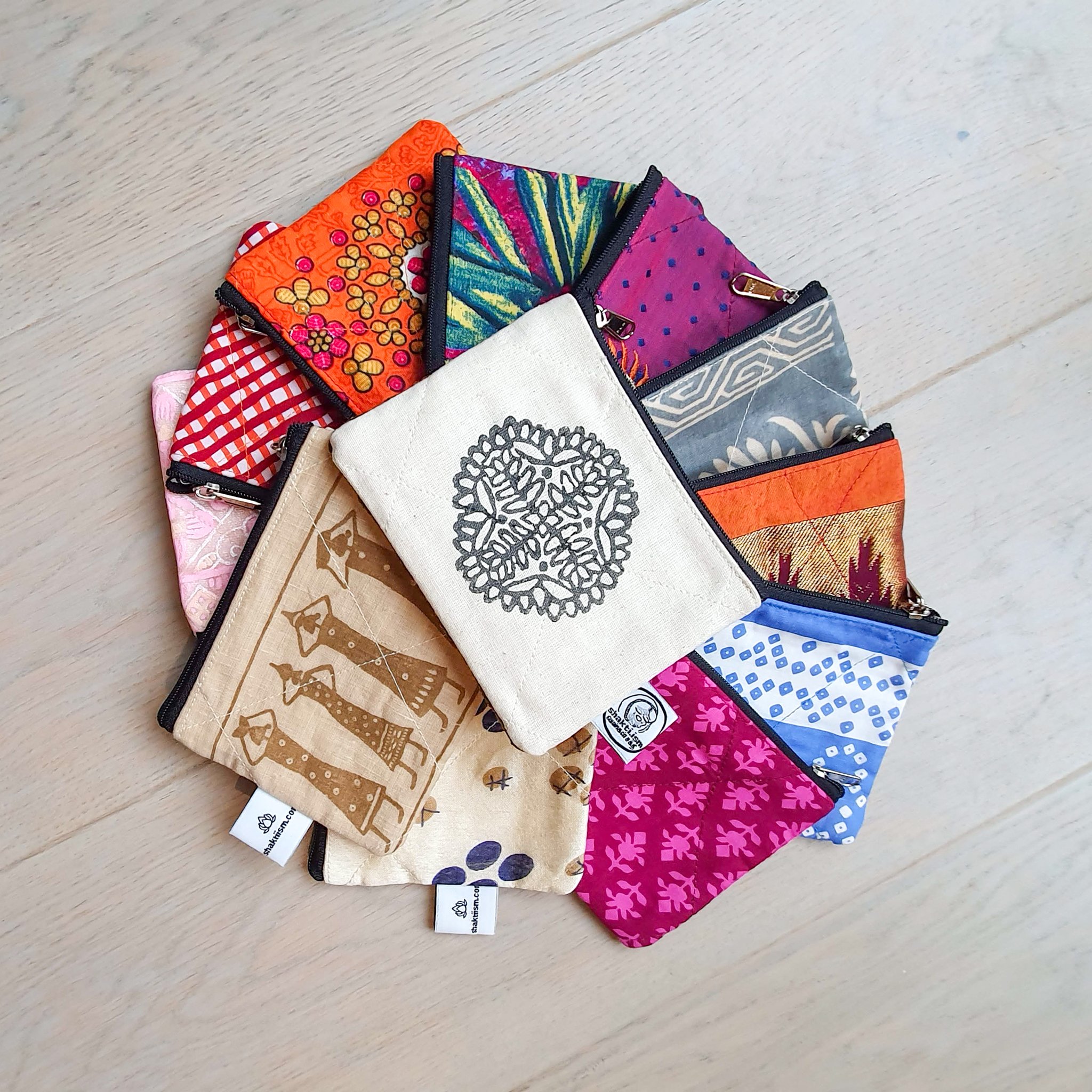 Colorful Sari coin purses made from reclaimed fabric, showcasing unique patterns and designs, ethically handmade by artisans in India.