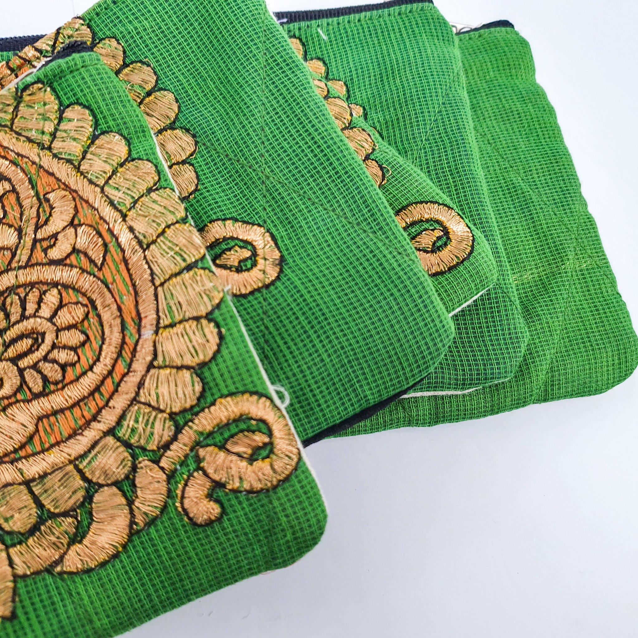 Colorful Sari coin purses made from reclaimed fabric, showcasing unique patterns and designs, ethically handmade by artisans in India.