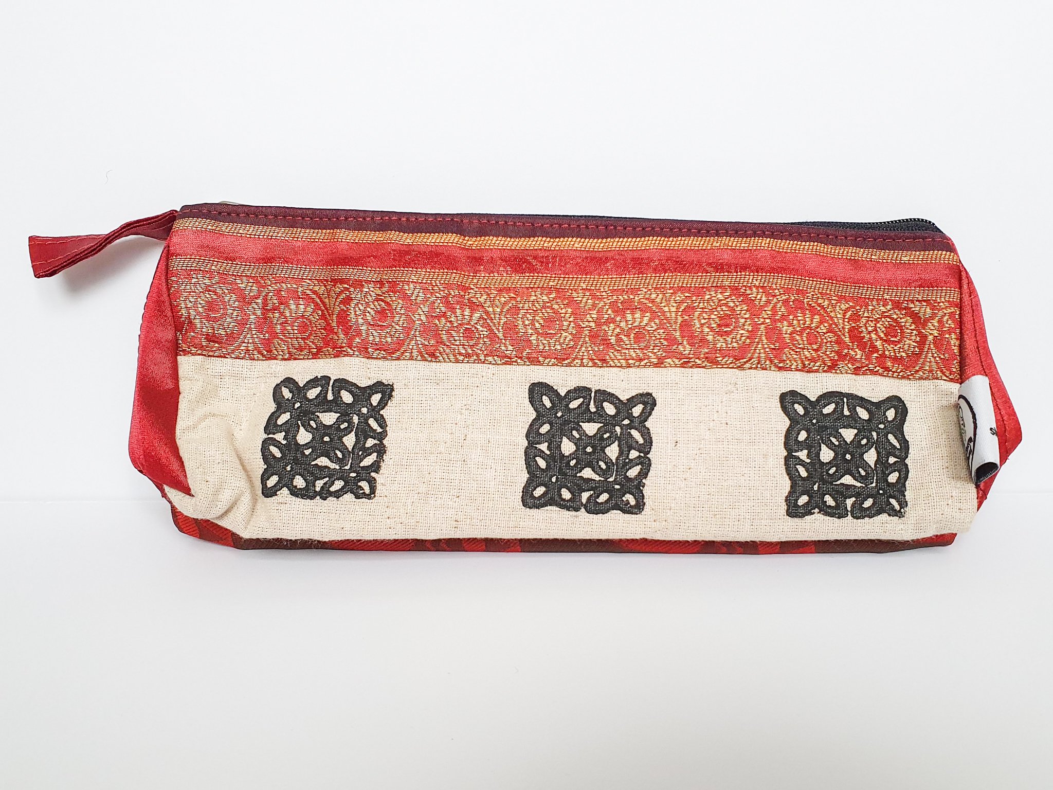 A vibrant Sari Pencil Pouch made from reclaimed sari fabric, showcasing unique patterns and colors, ethically handmade by artisans in India.